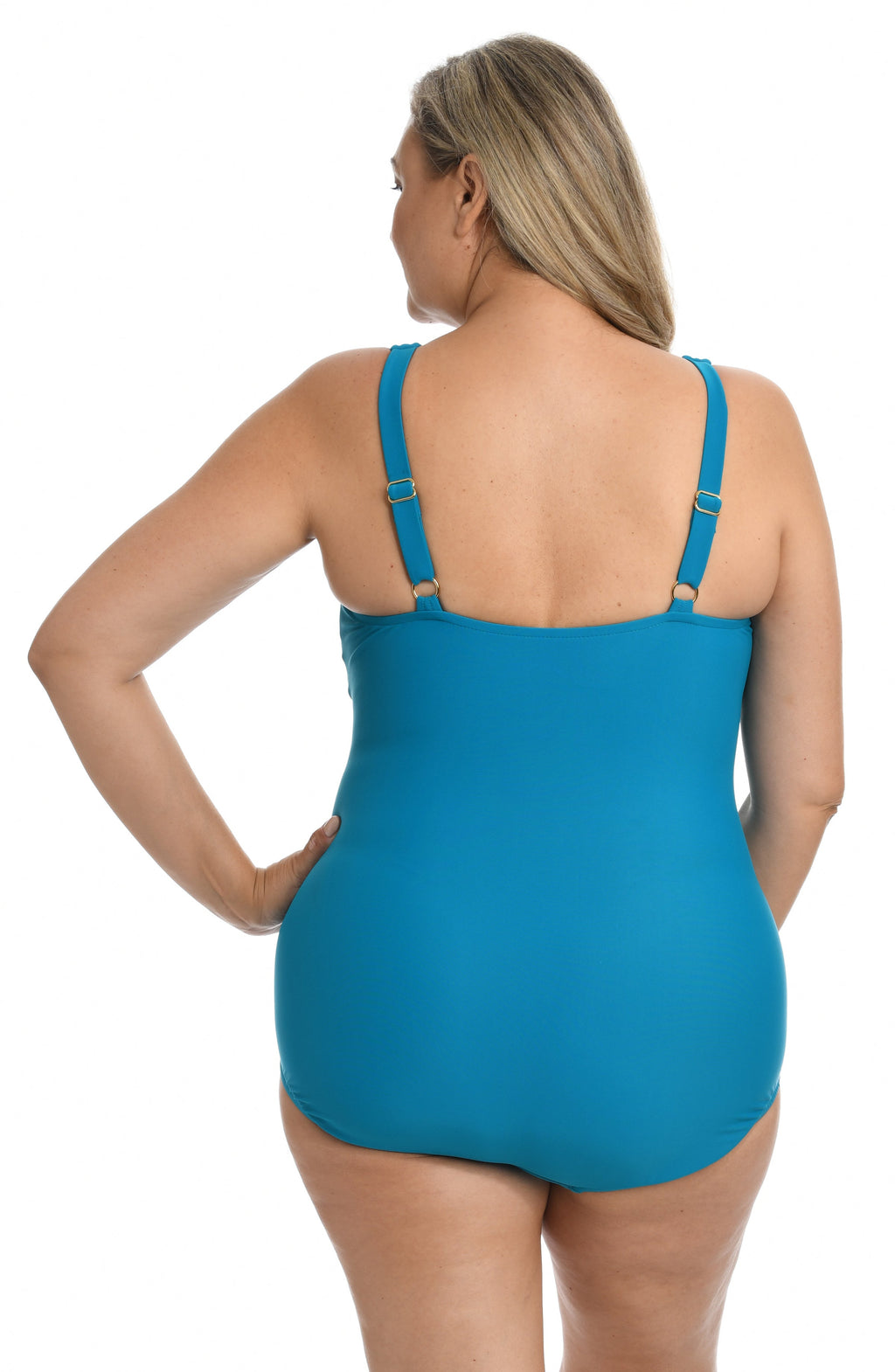 Woman wearing a emerald colored swimsuit on a white background