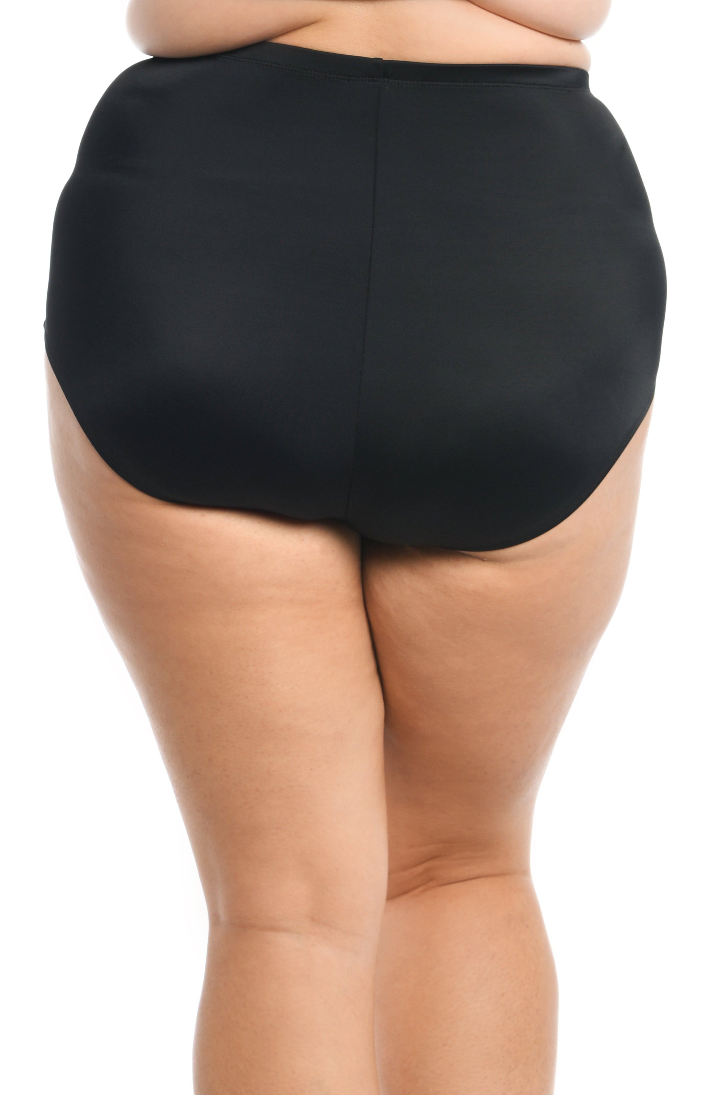 Black high-waisted swim bottoms worn by a person on a white background