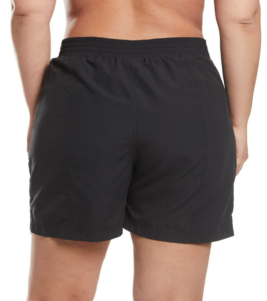 Black board shorts worn by a person on a white background
