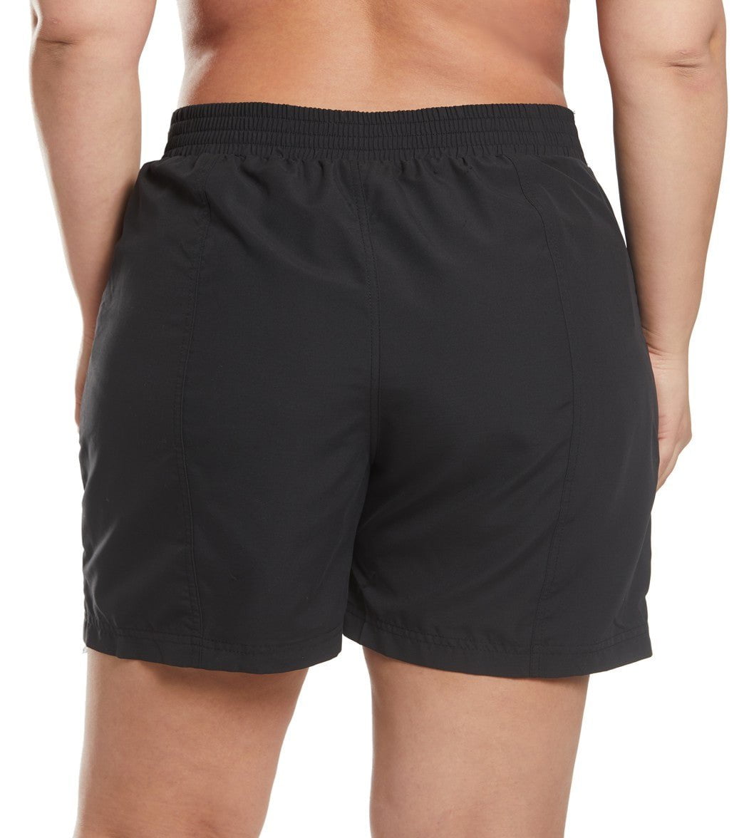 Black board shorts worn by a person on a white background