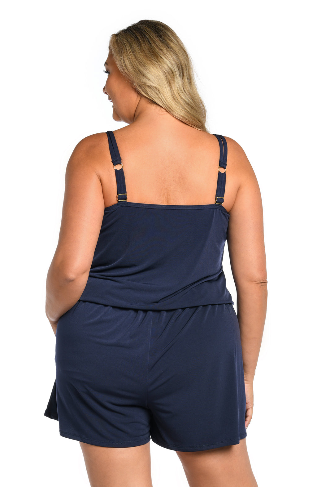 Woman wearing a navy blue swim romper one piece set on a white background