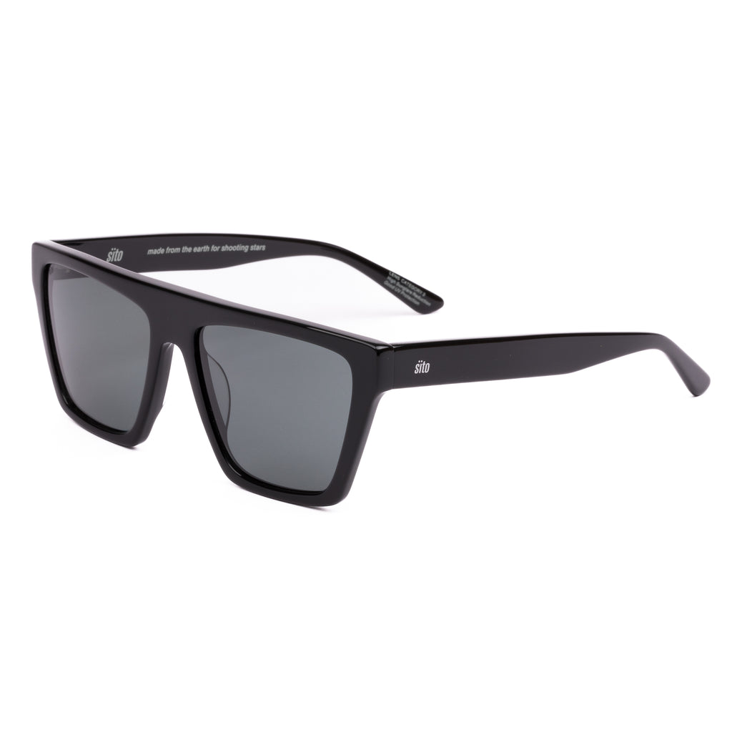 Black sunglasses with dark lenses on a white background
