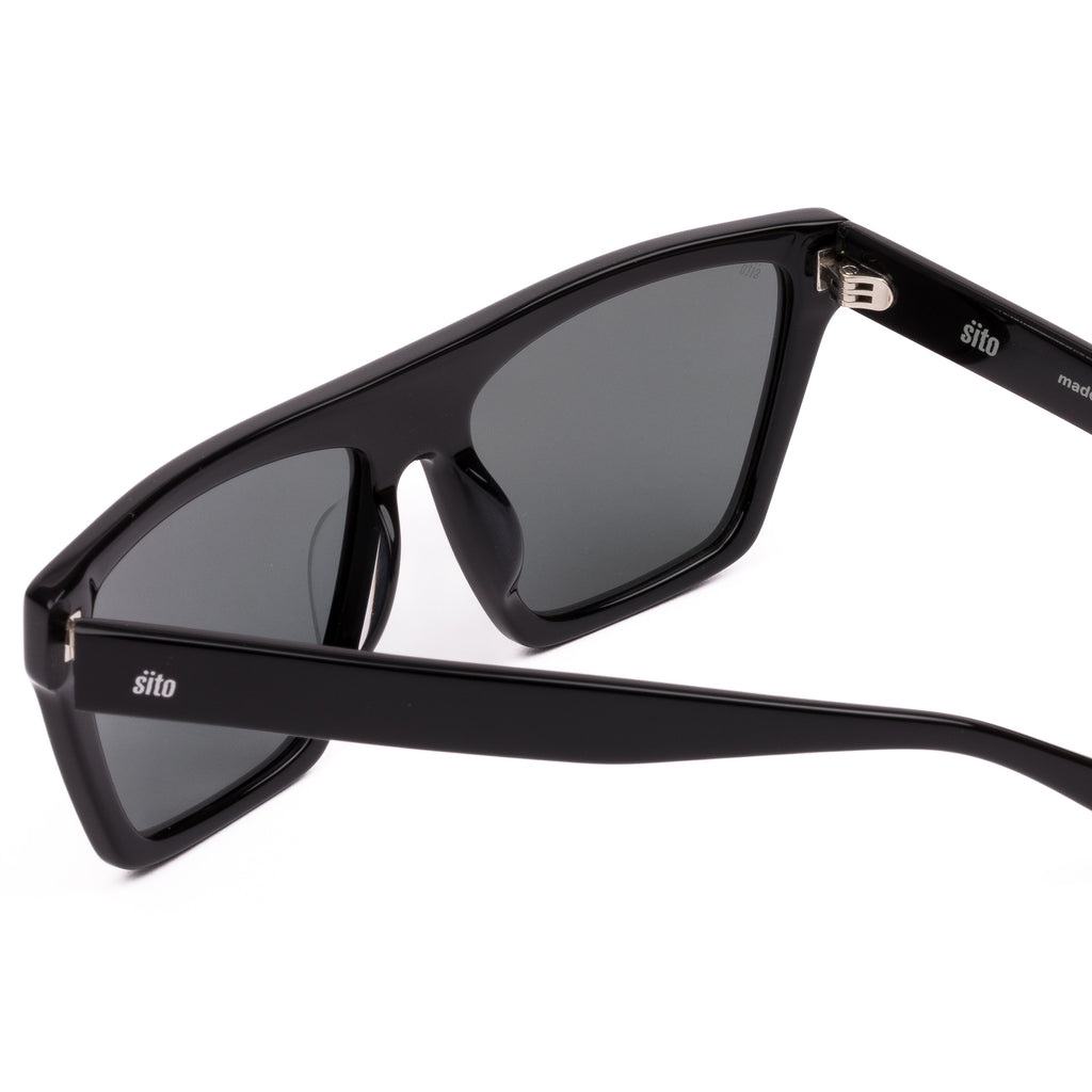 Black sunglasses with dark lenses on a white background