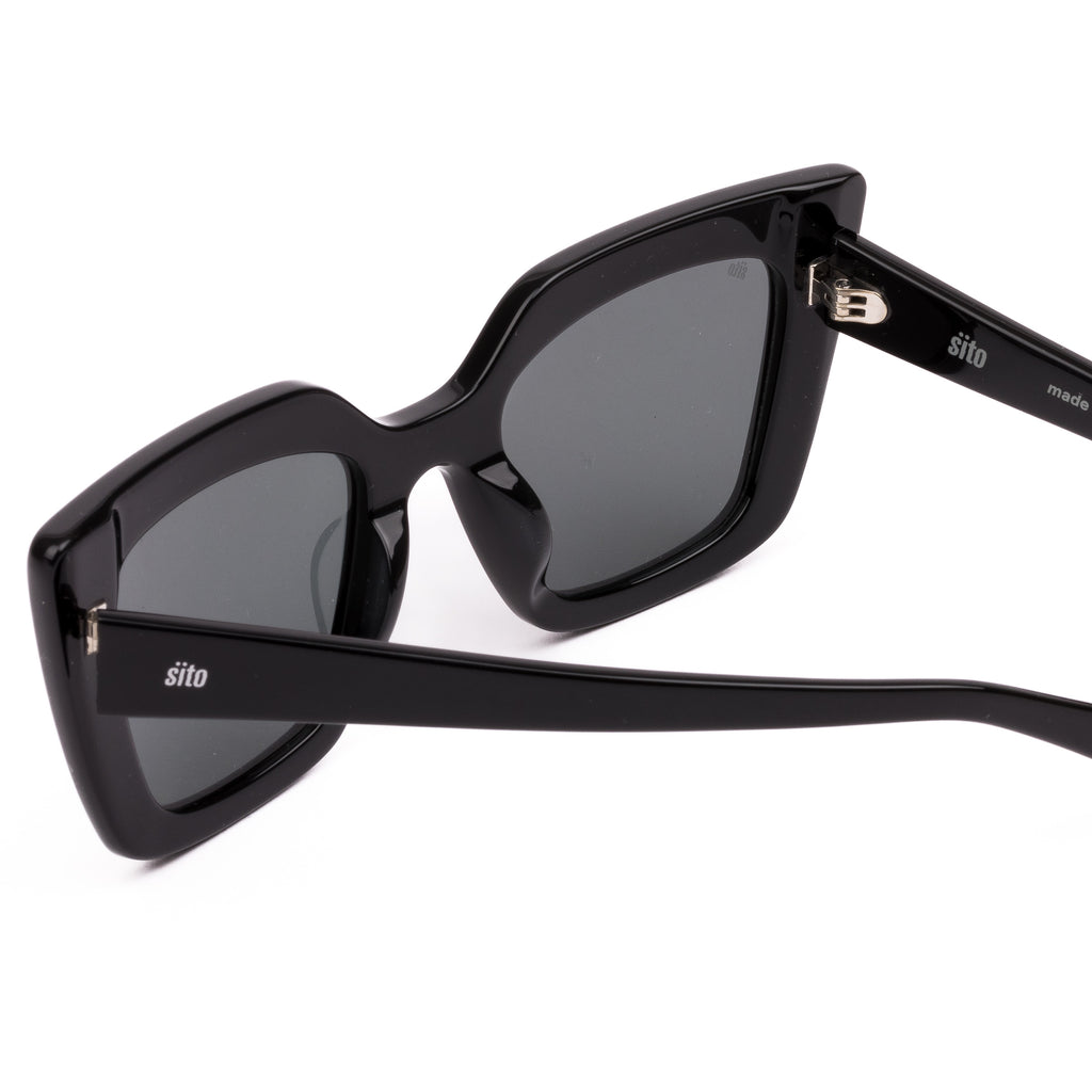 Black sunglasses with dark lenses on a white background