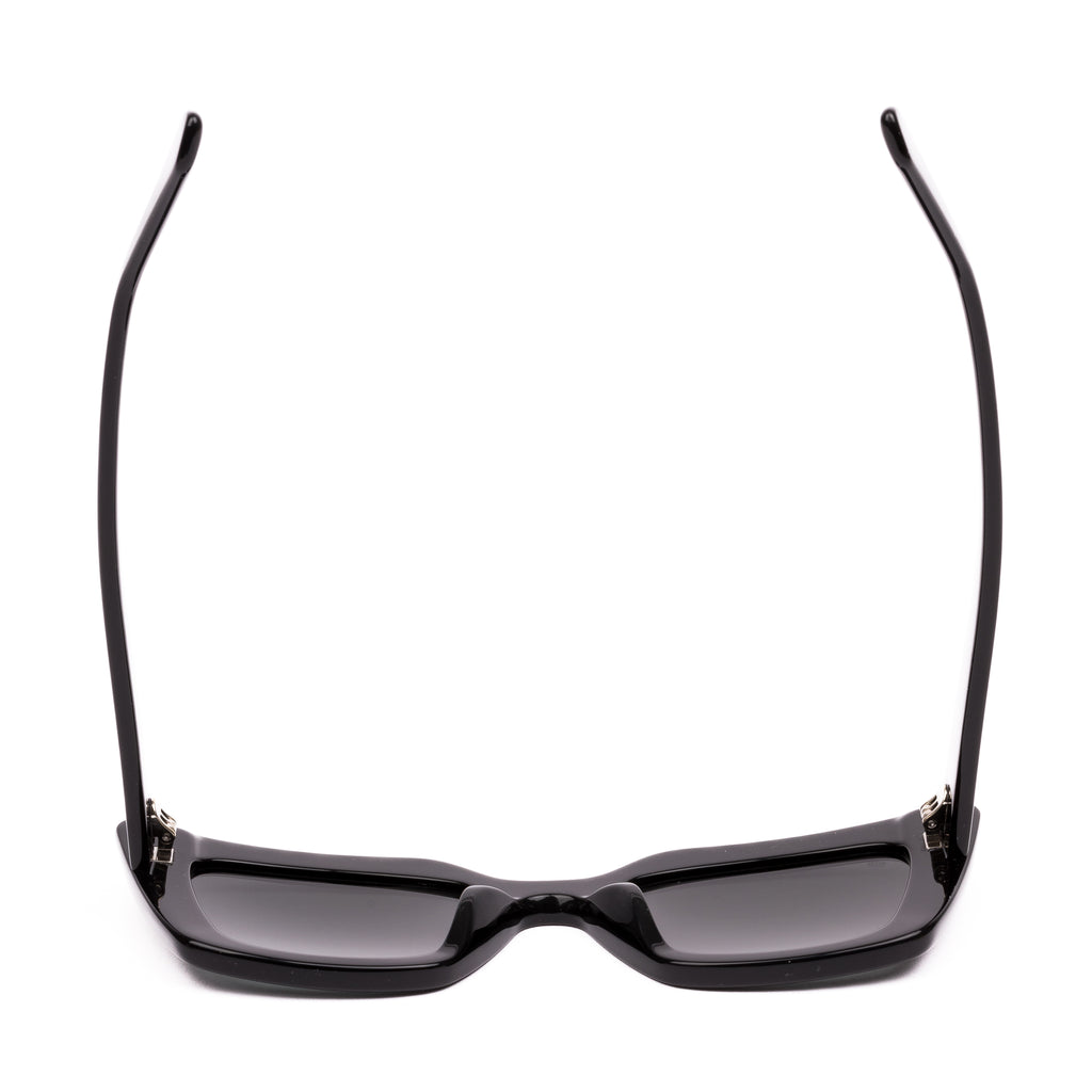 Black sunglasses with dark lenses on a white background