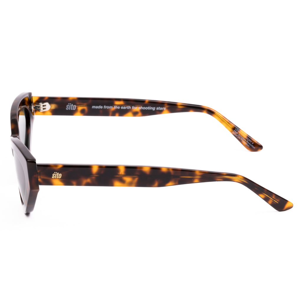 Cat-eye sunglasses with tortoiseshell frame and dark lenses on a white background