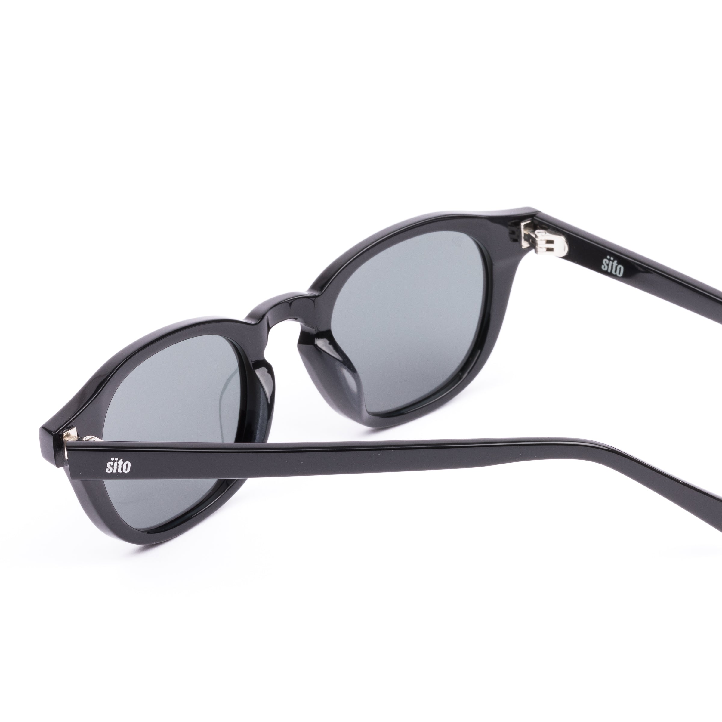 Black sunglasses with reflective lenses on a white background