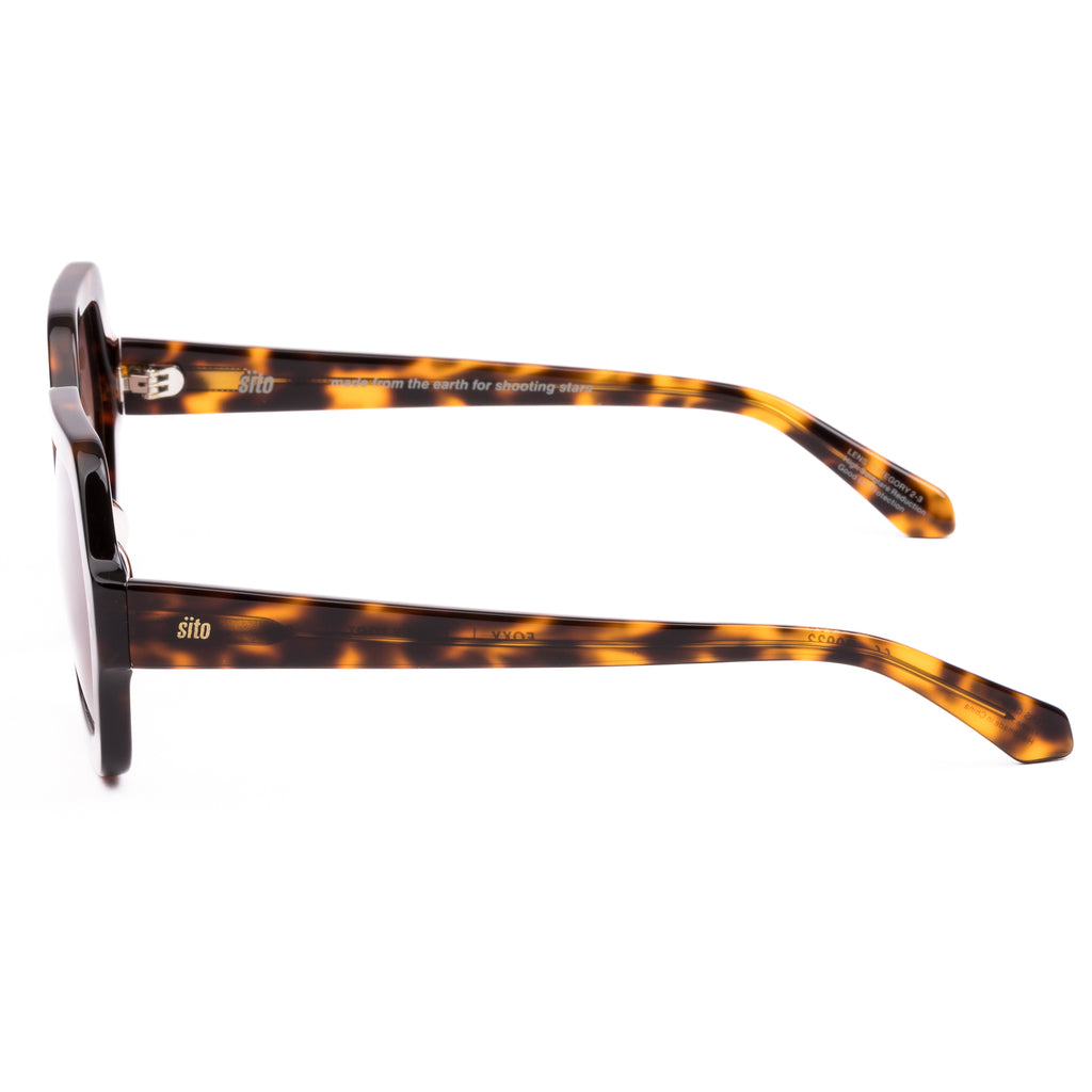 Sunglasses with tortoiseshell frame and gradient lenses on a white background