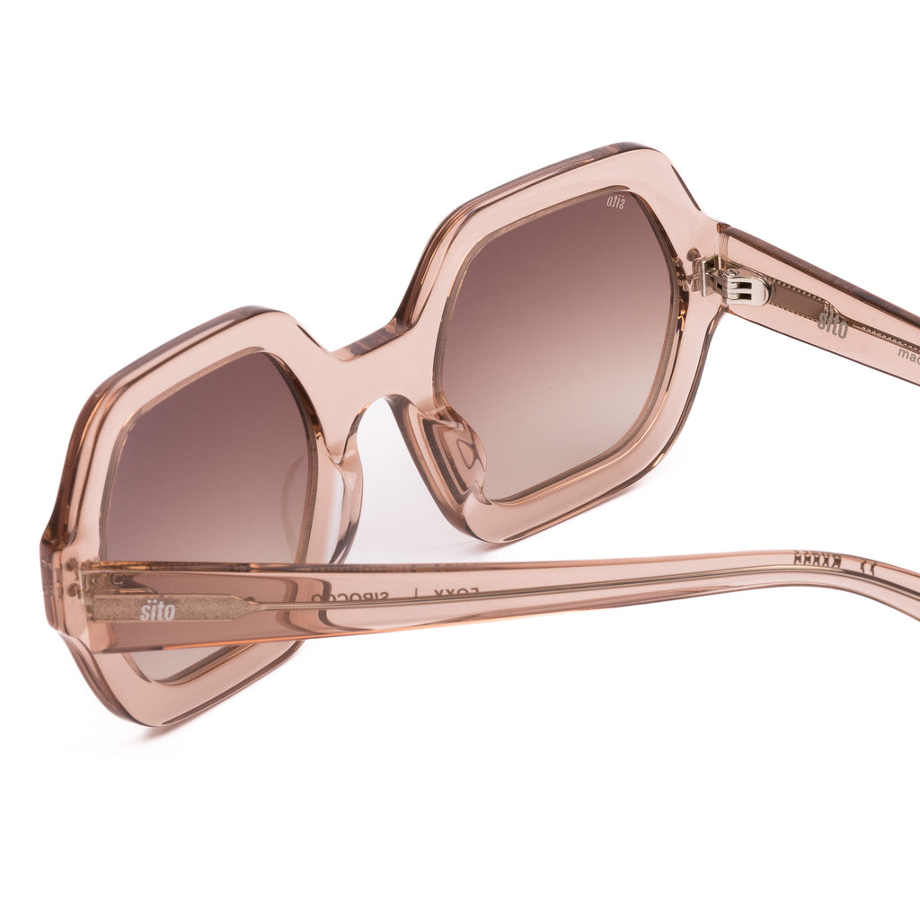 Pink sunglasses with gradient lenses on a white background
