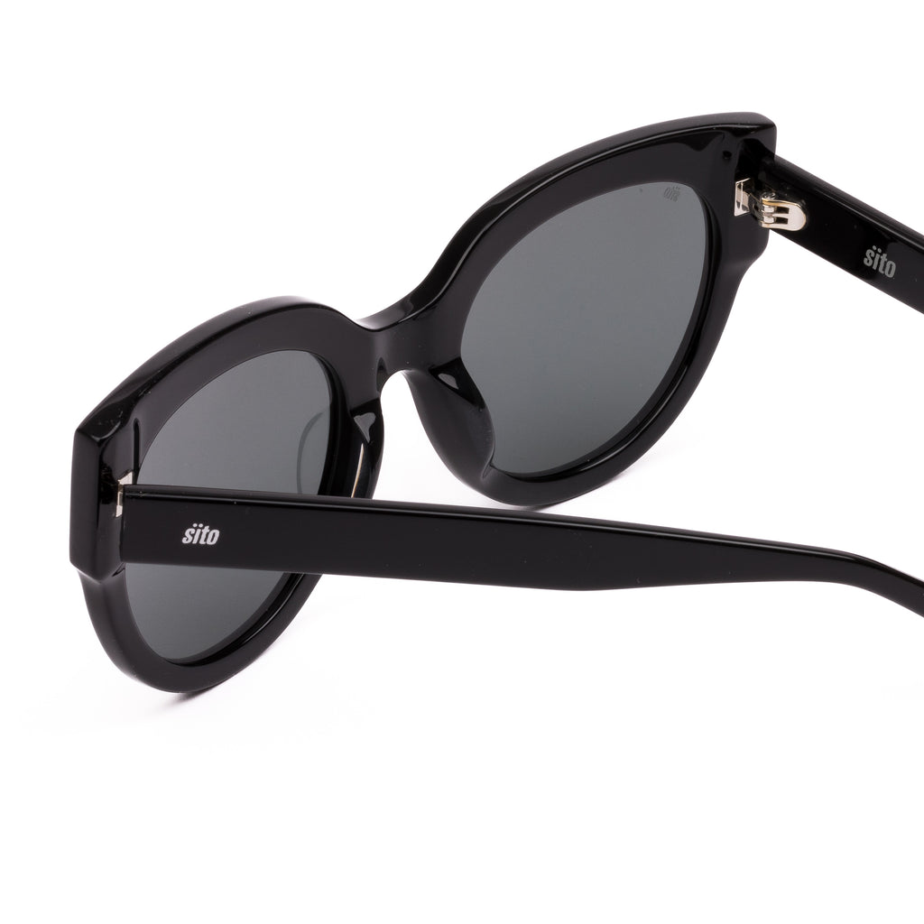 Black sunglasses with dark lenses on a white background