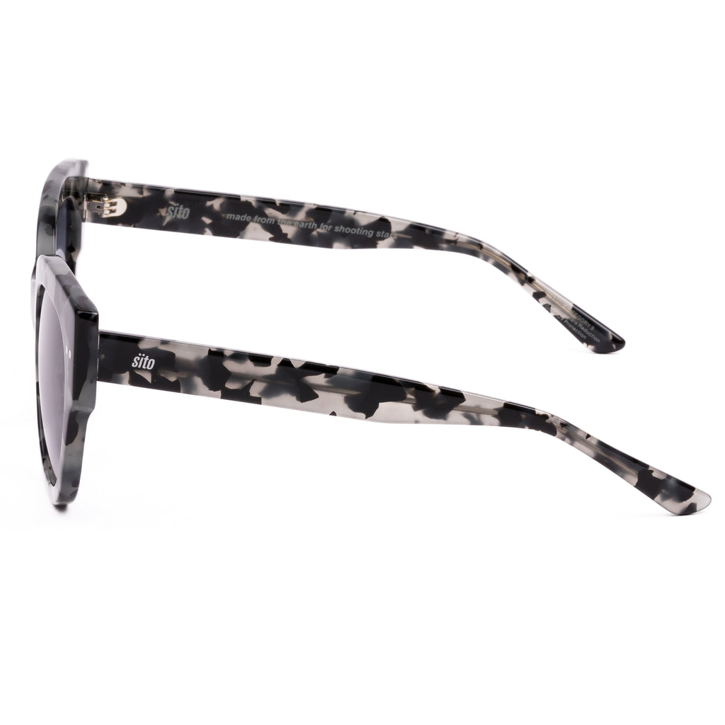 Sunglasses with tortoiseshell frame and gray lenses on a white background