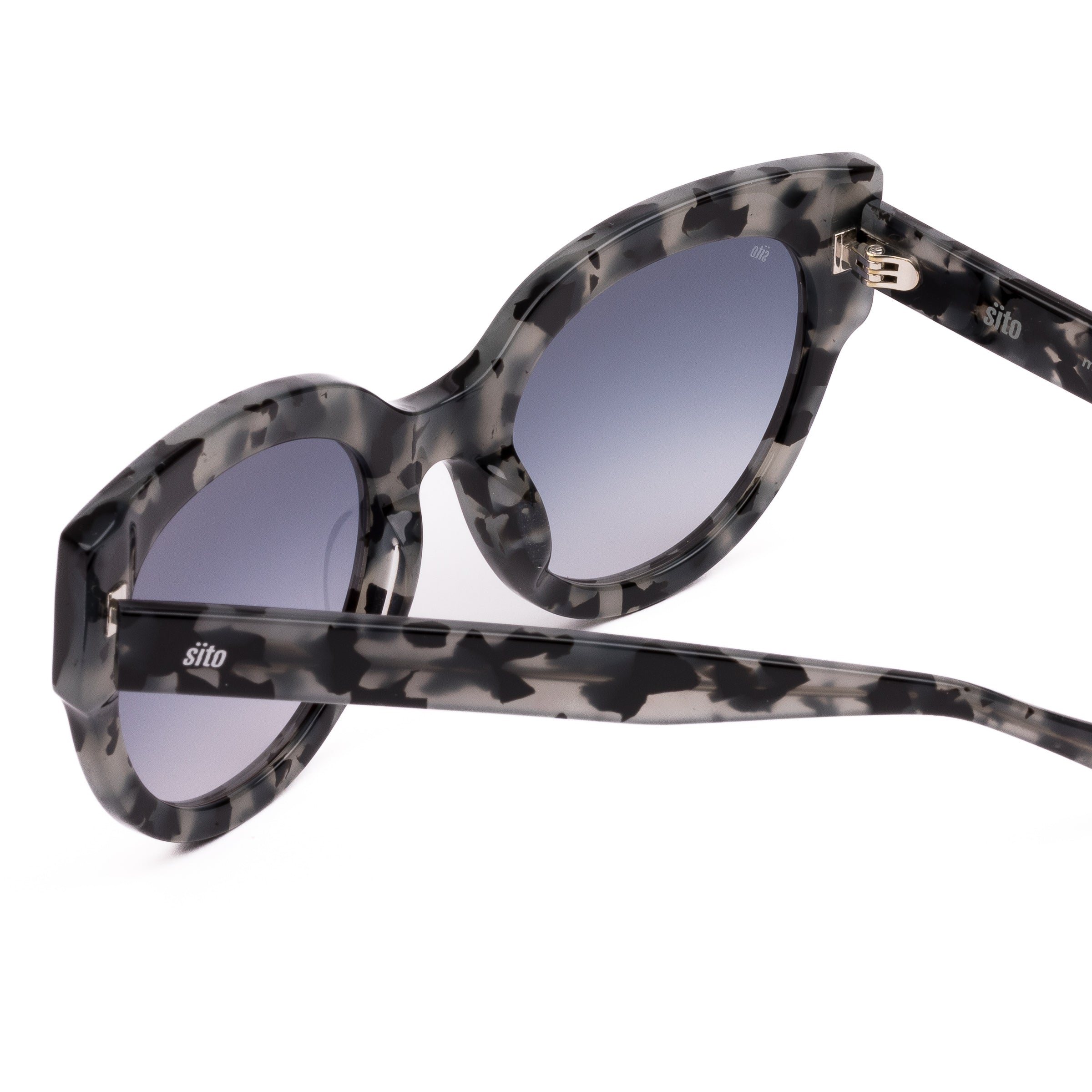 Sunglasses with tortoiseshell frame and gray lenses on a white background