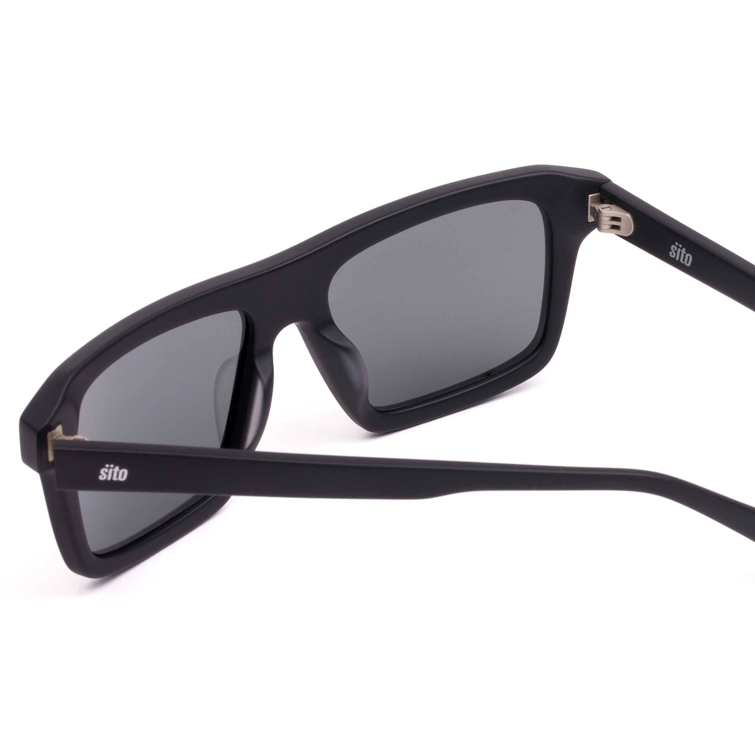 Black sunglasses with dark lenses on a white background
