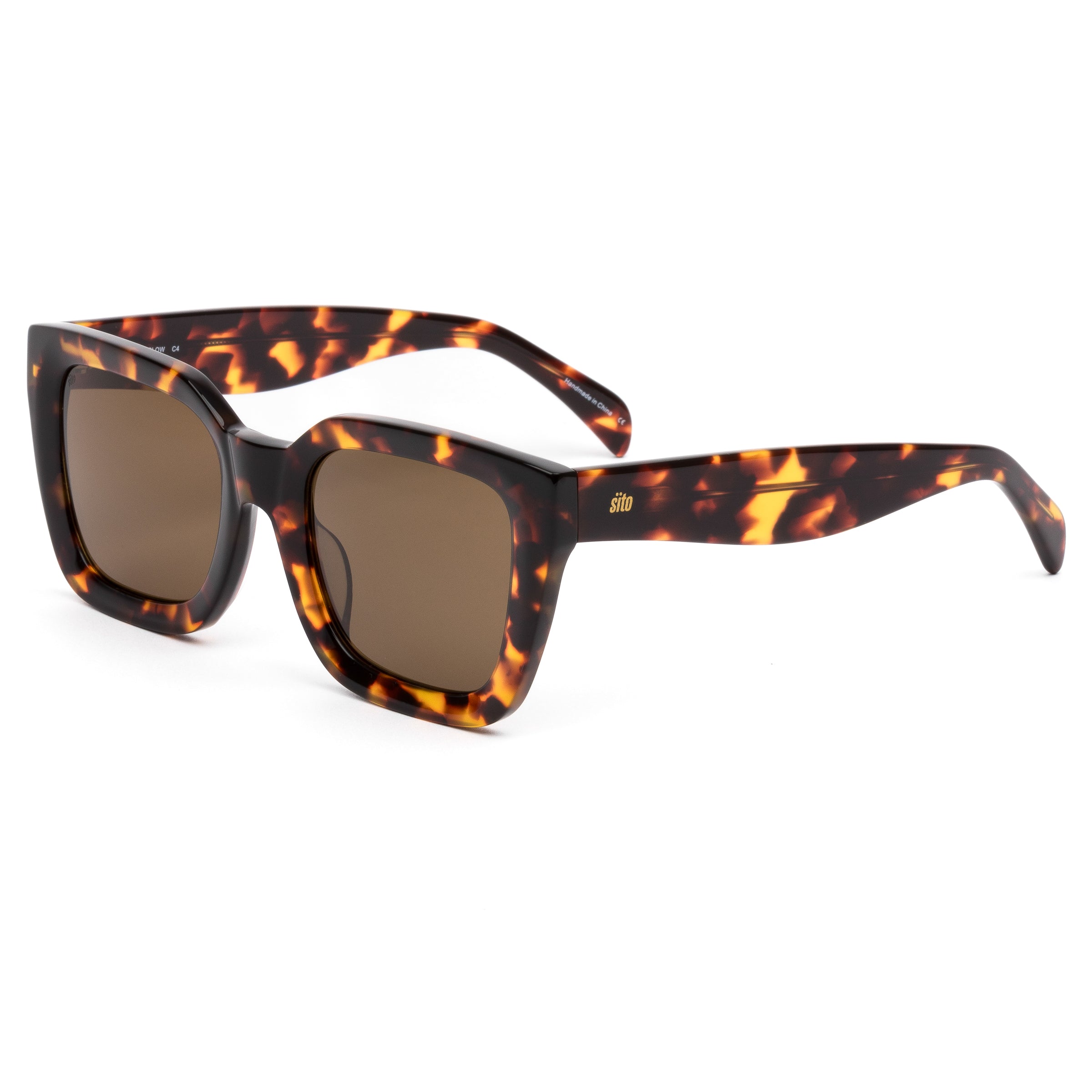 Sunglasses with tortoiseshell frame and brown lenses on a white background