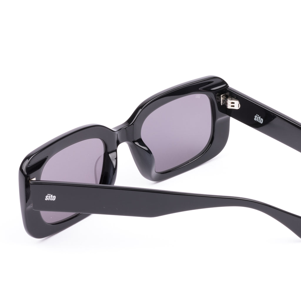 Black sunglasses with gray lenses on a white background