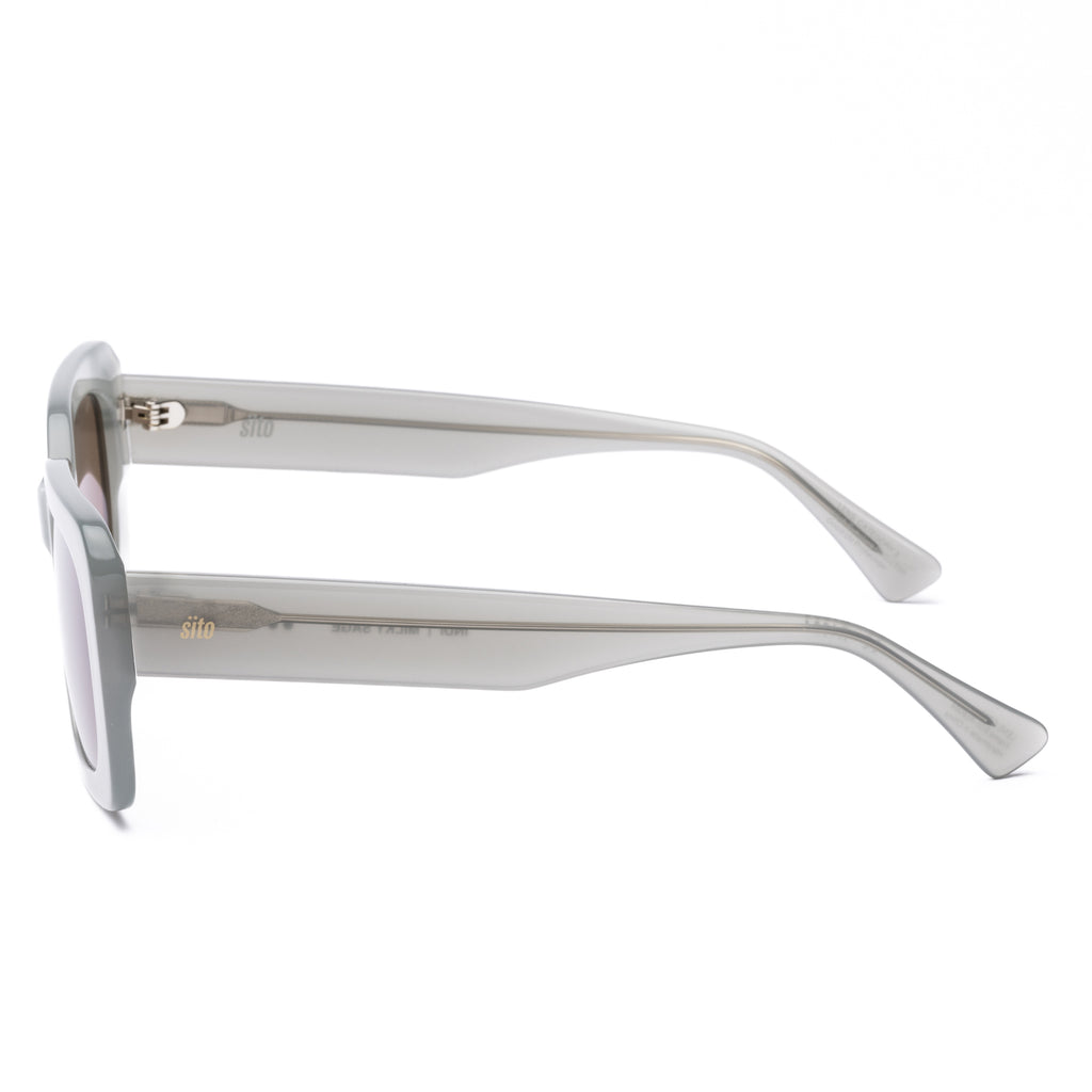 White sunglasses with brown lenses on a white background