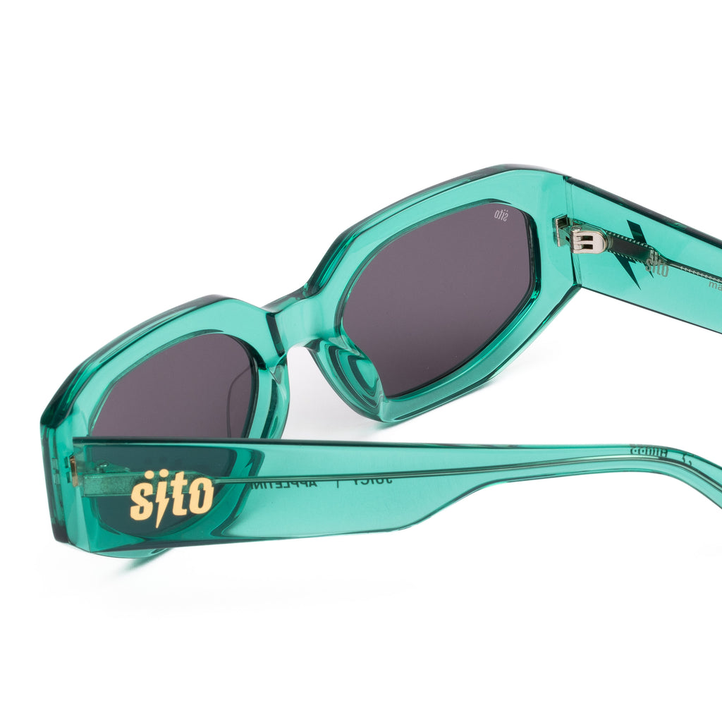 Teal sunglasses with dark lenses on a white background