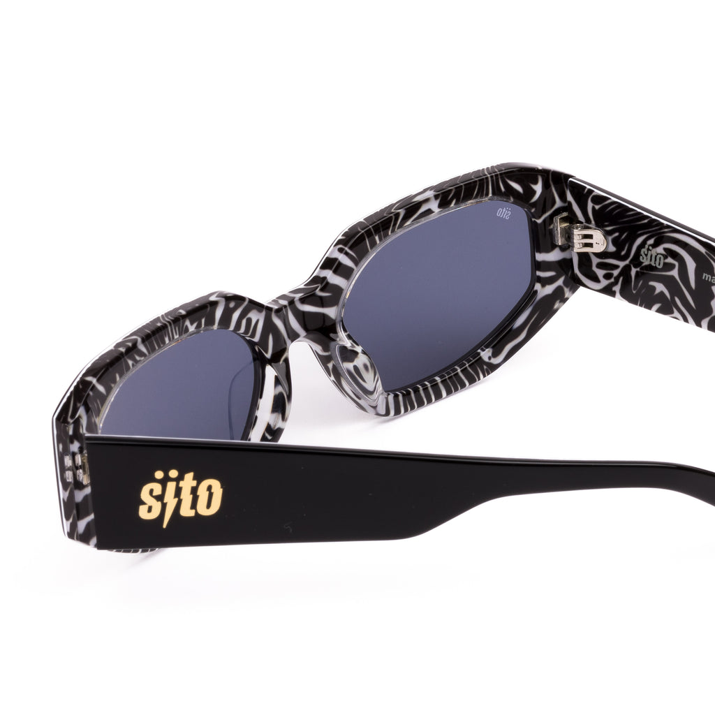 Sunglasses with black and white patterned arms and 'sifto' branding on a white background
