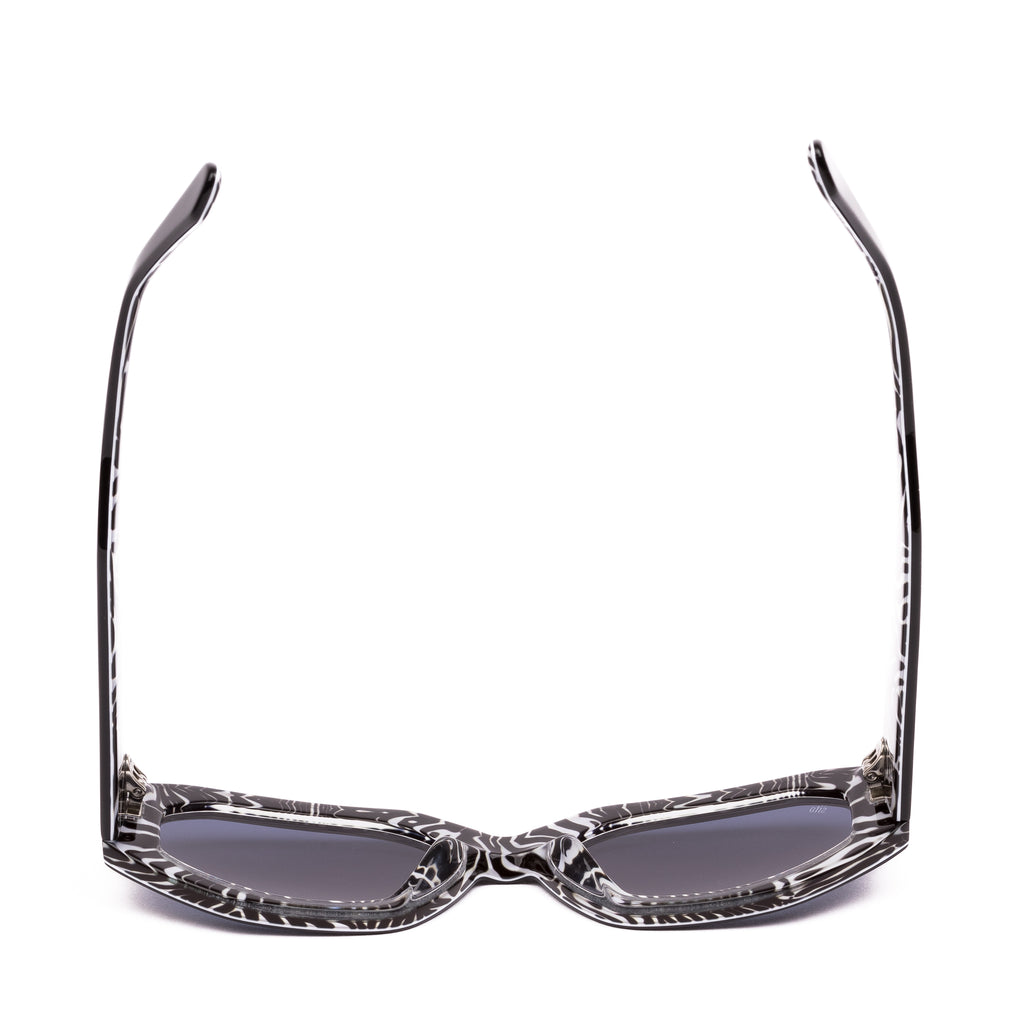 Sunglasses with black and white patterned frames on a white background