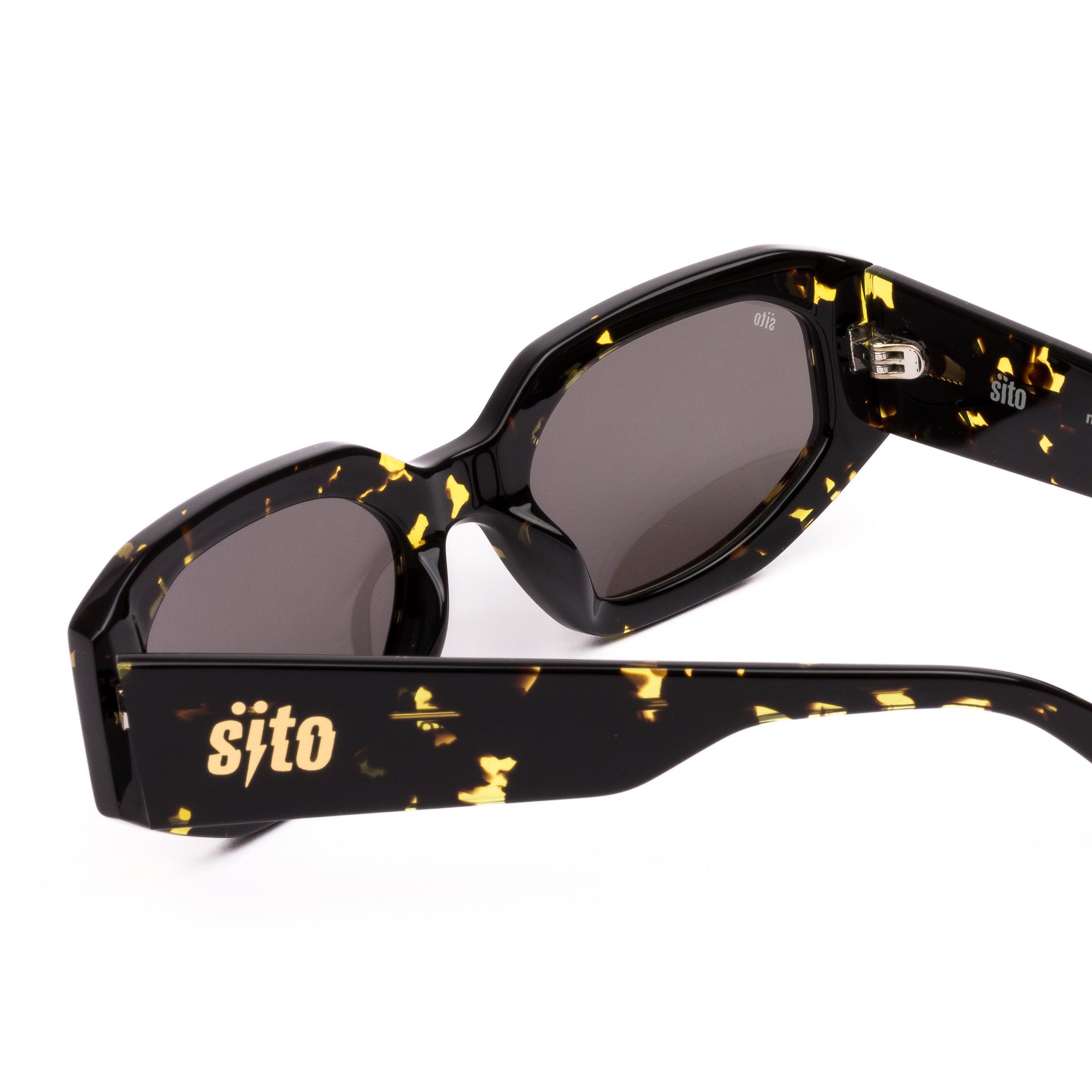 Sunglasses with black and gold tortoiseshell frame on a white background