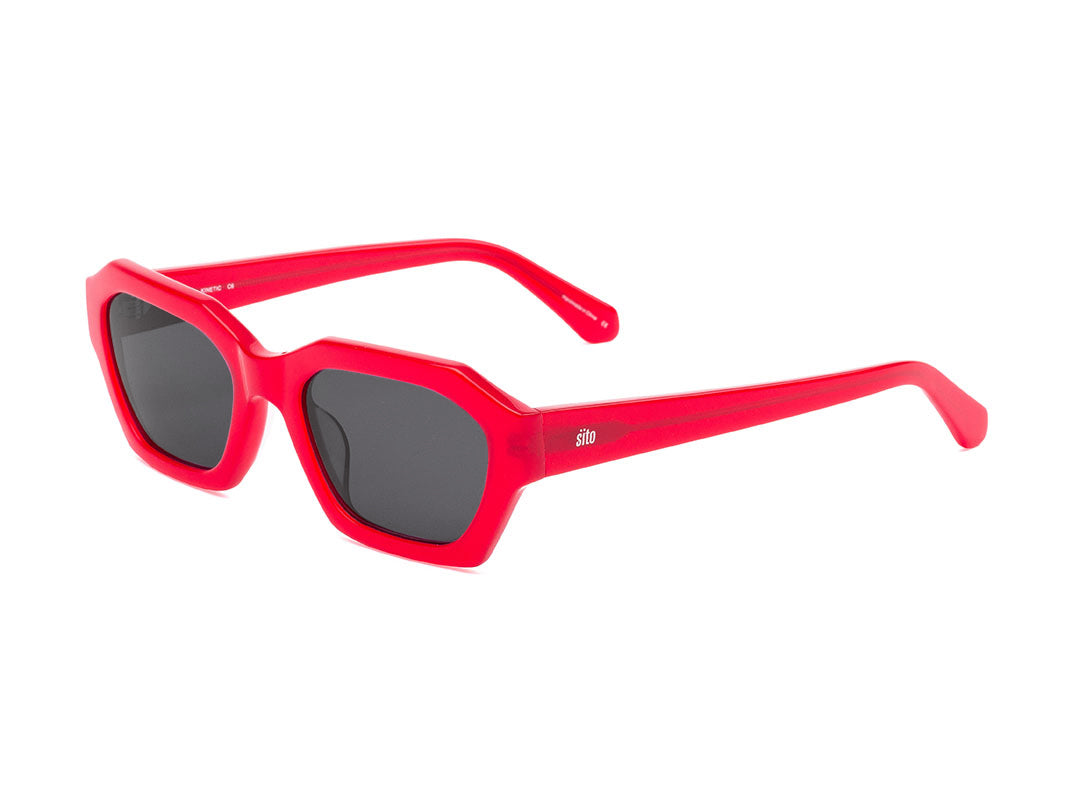 Red sunglasses with dark lenses on a white background