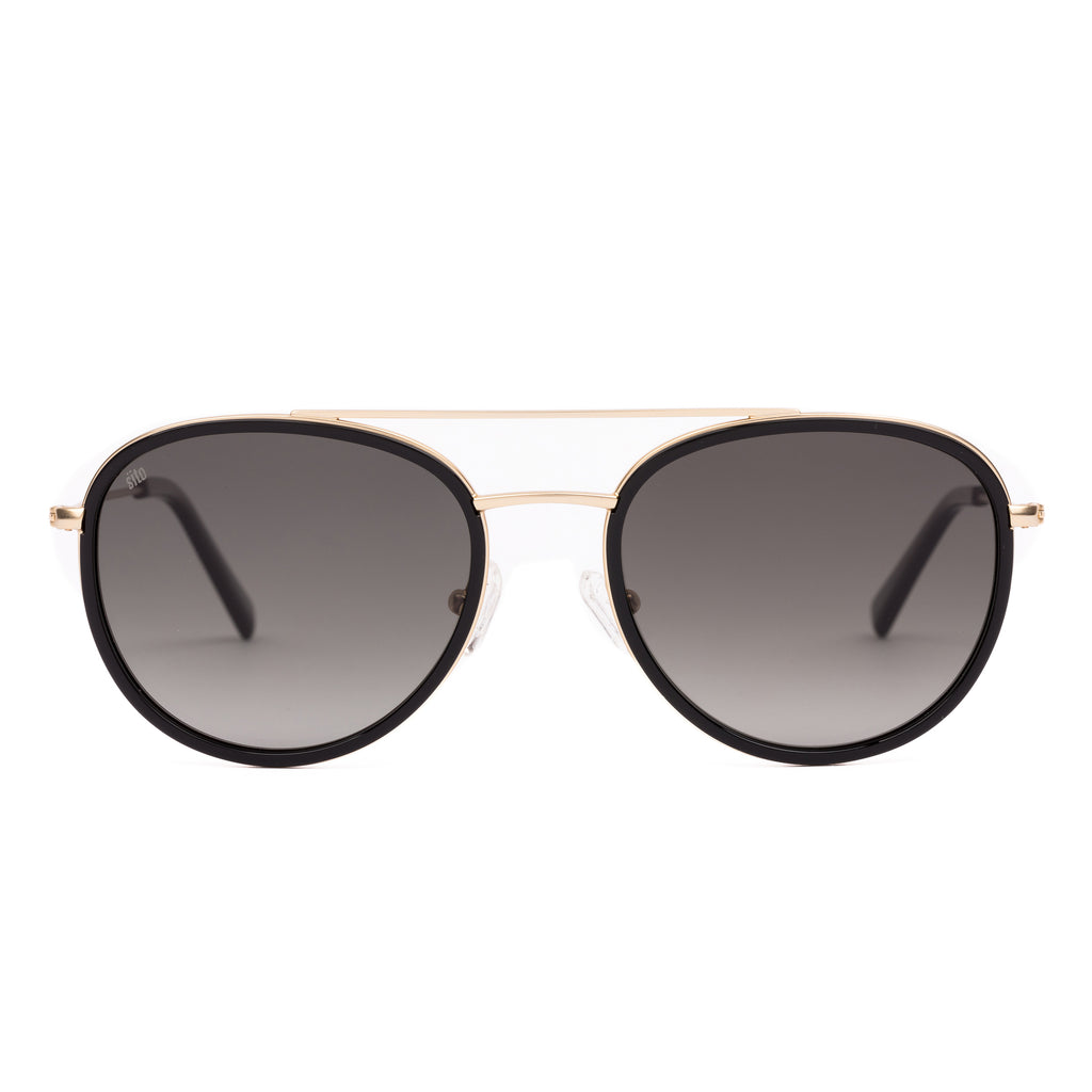 Sunglasses with gold frame and dark lenses on a white background
