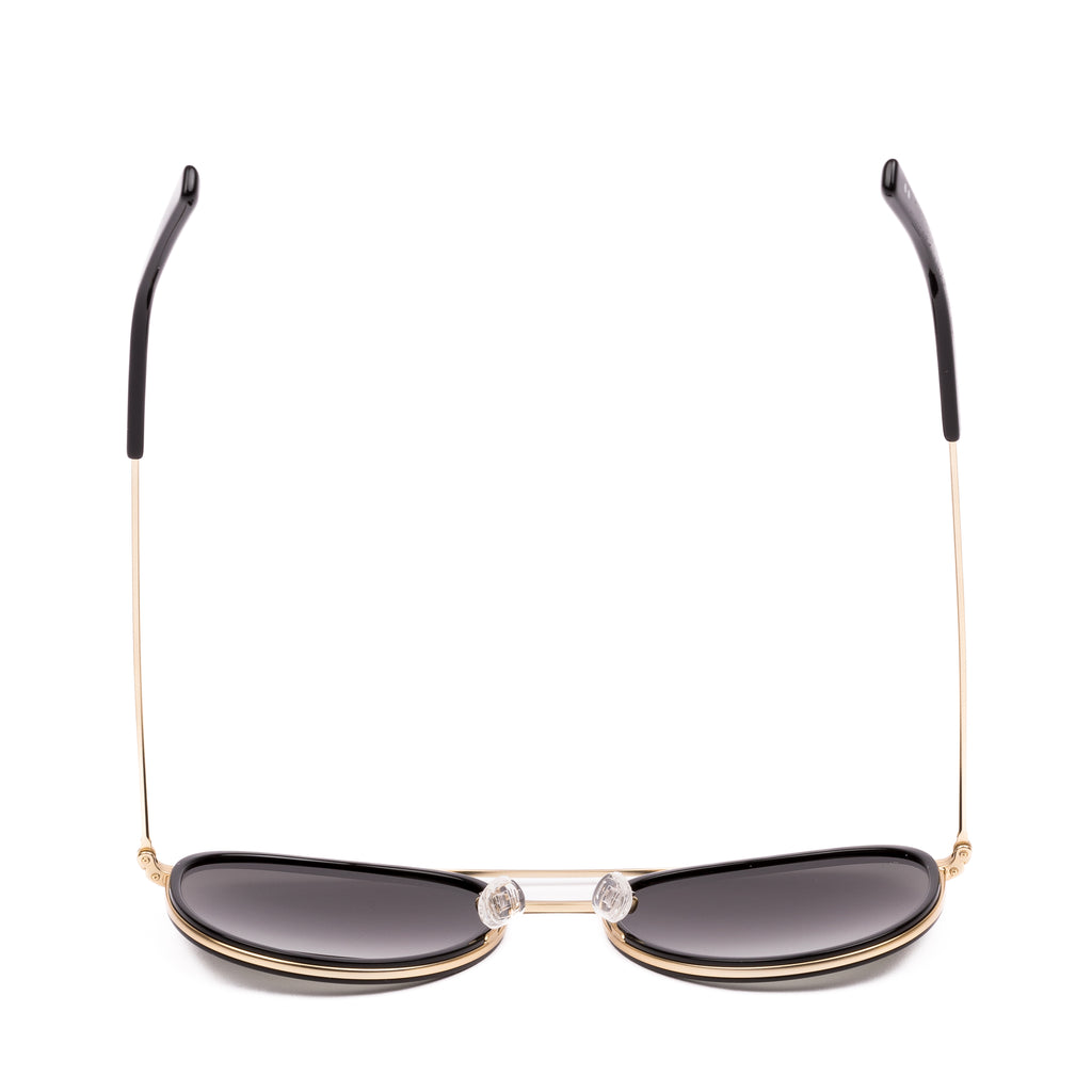 Sunglasses with gold frame and dark lenses on a white background