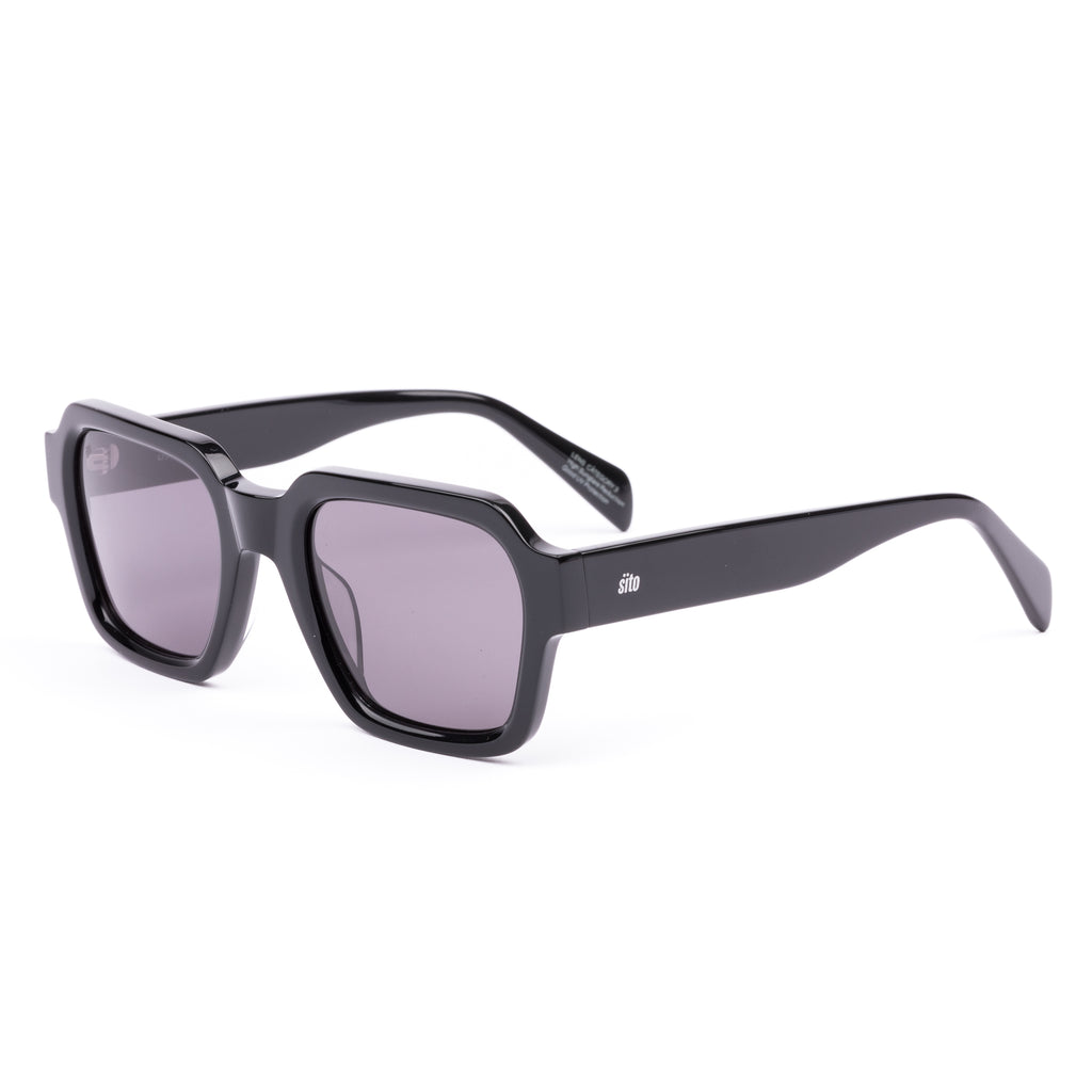 Black sunglasses with a glossy black finish and softly tinted lenses.