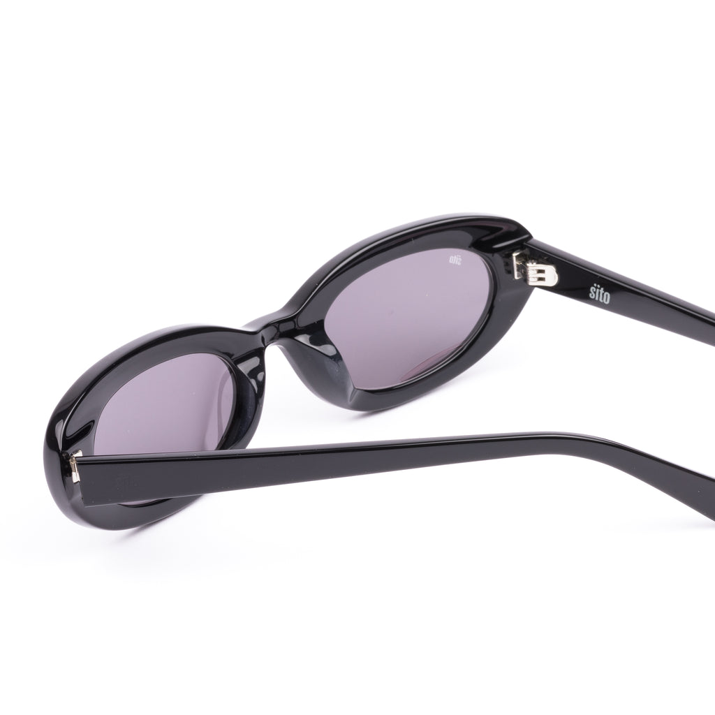 Black sunglasses with purple lenses on a white background