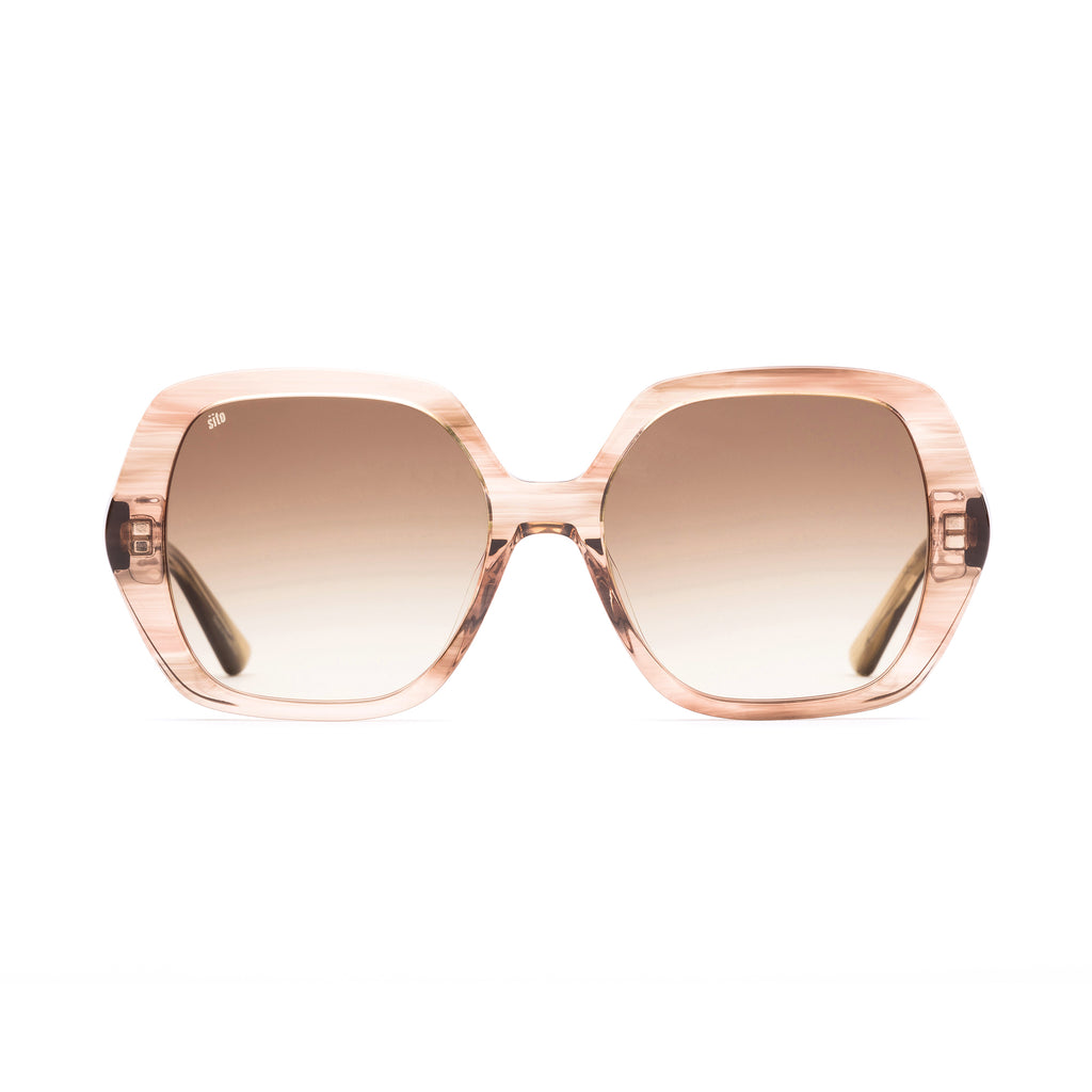 Sunglasses with rose gold frame and gradient lenses on a white background
