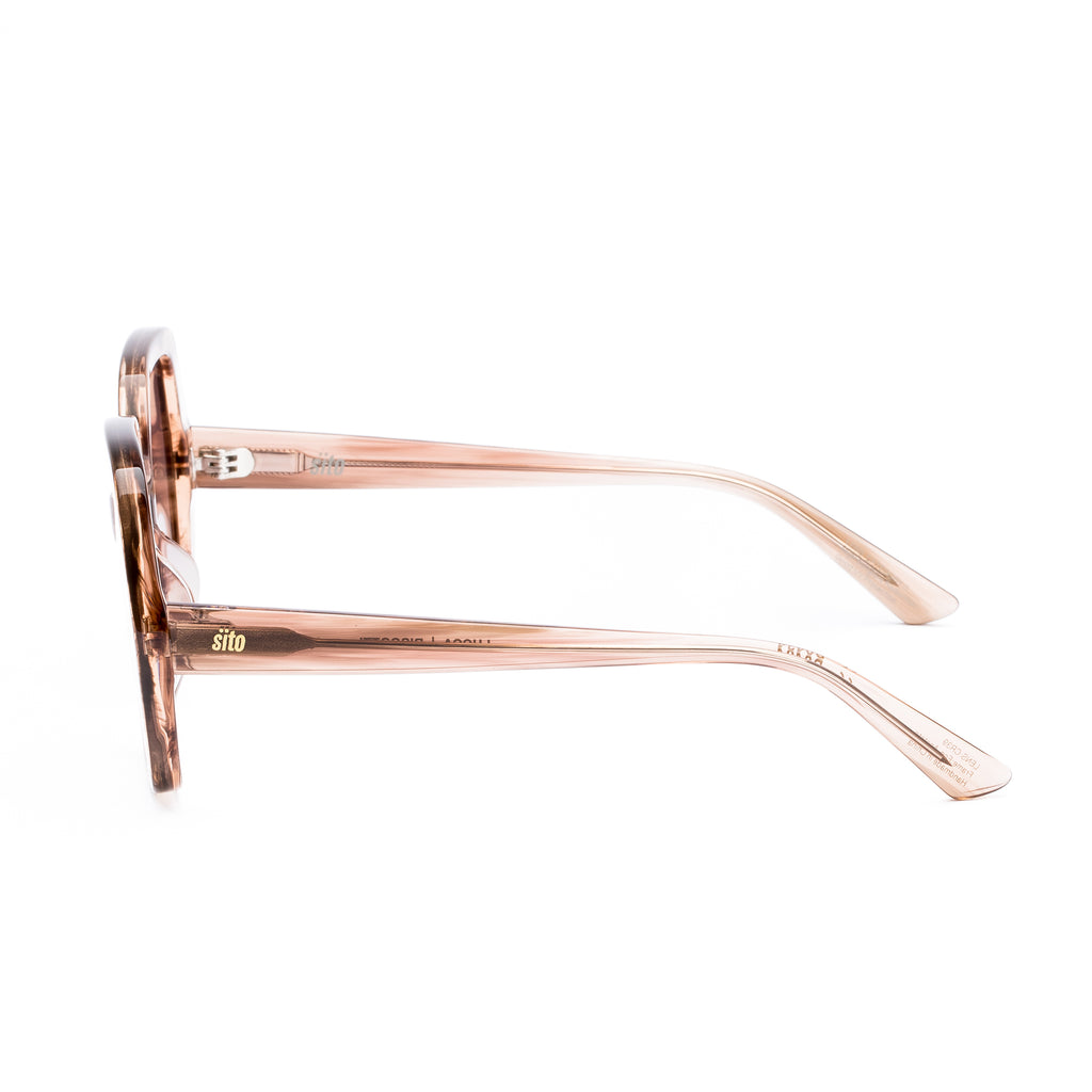 Sunglasses with rose gold frame and gradient lenses on a white background
