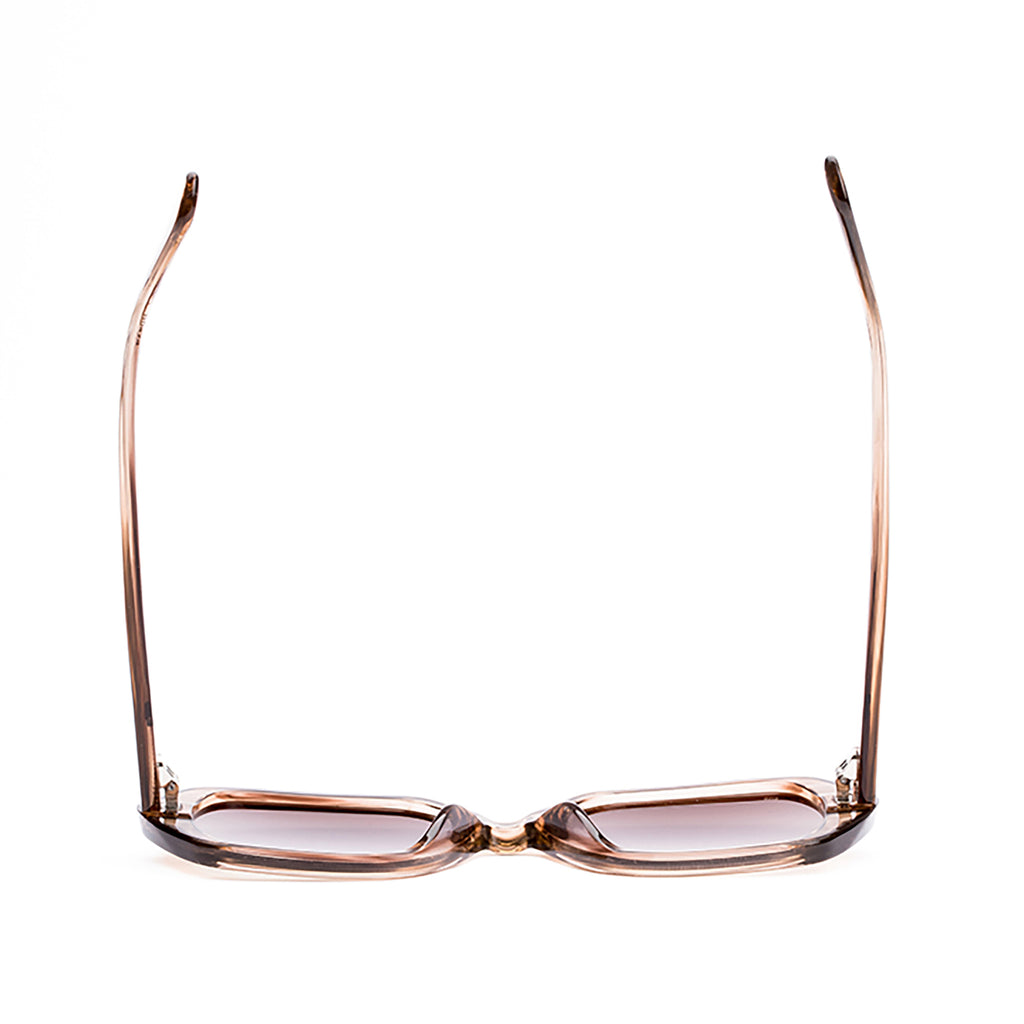 Sunglasses with rose gold frame and gradient lenses on a white background