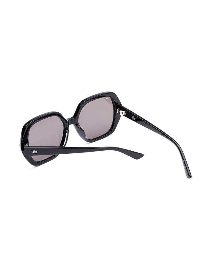 Black sunglasses with reflective lenses on a white background