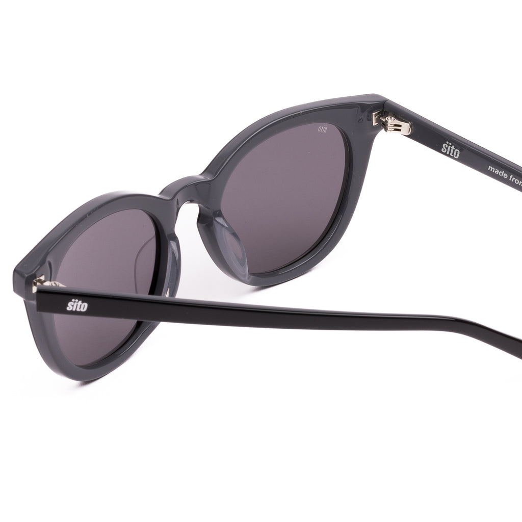 Black sunglasses with dark lenses on a white background