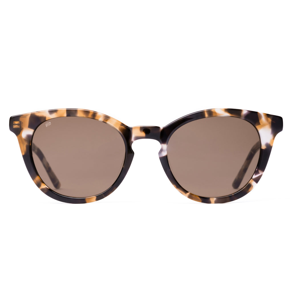 Sunglasses with tortoiseshell frame and brown lenses on a white background