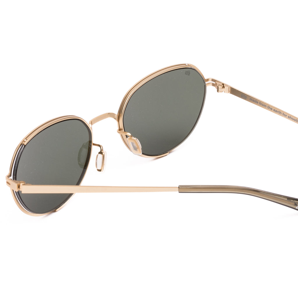 Gold-framed sunglasses with dark lenses on a white background