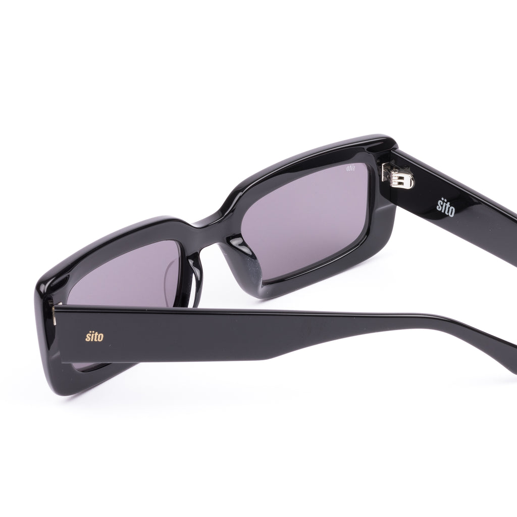 Black sunglasses with gray lenses on a white background