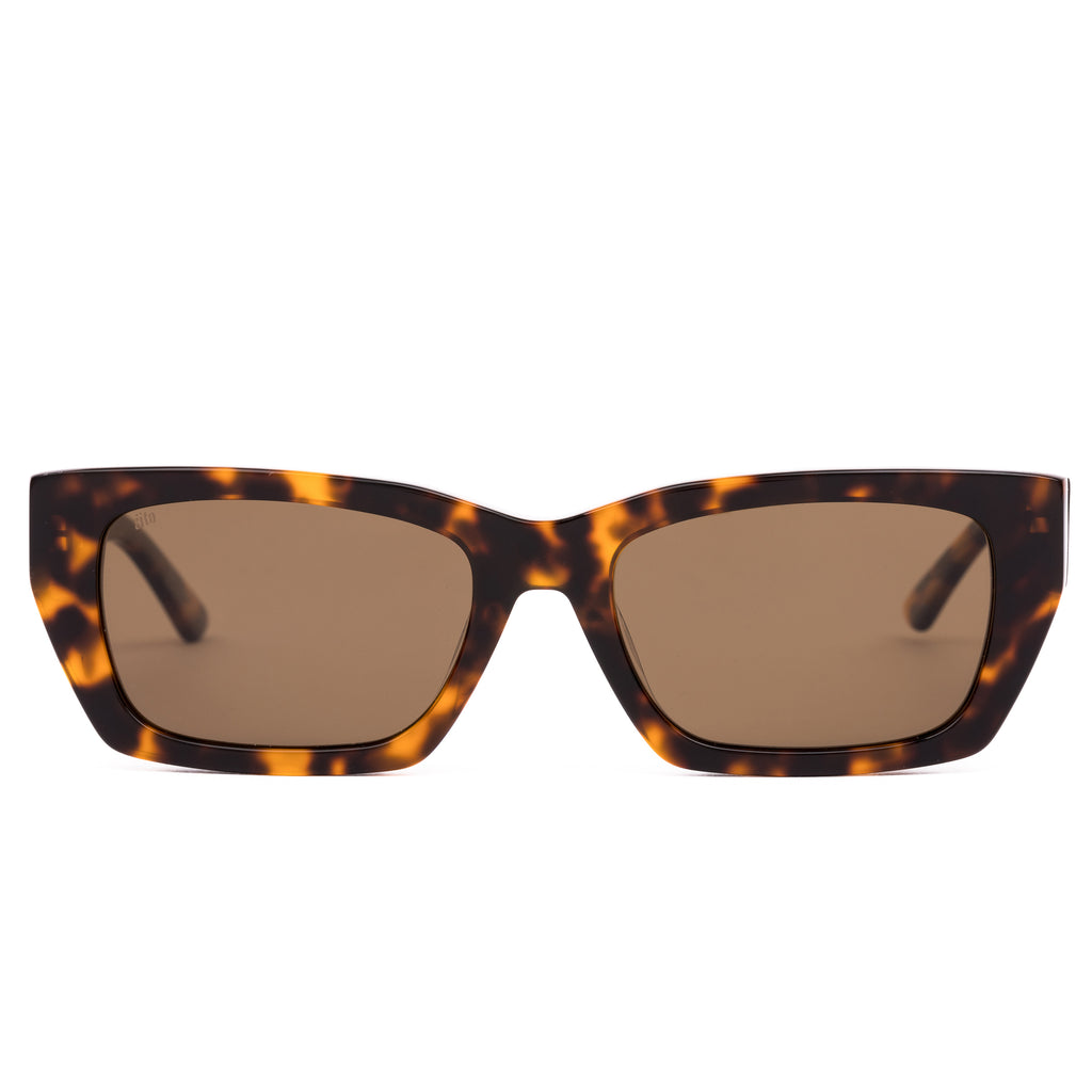 Sunglasses with tortoiseshell frame and brown lenses on a white background