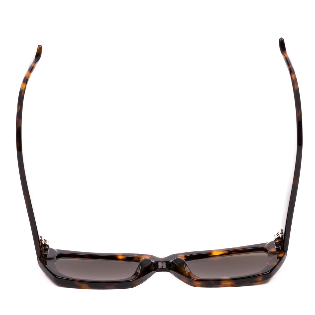 Sunglasses with tortoiseshell frame and brown lenses on a white background
