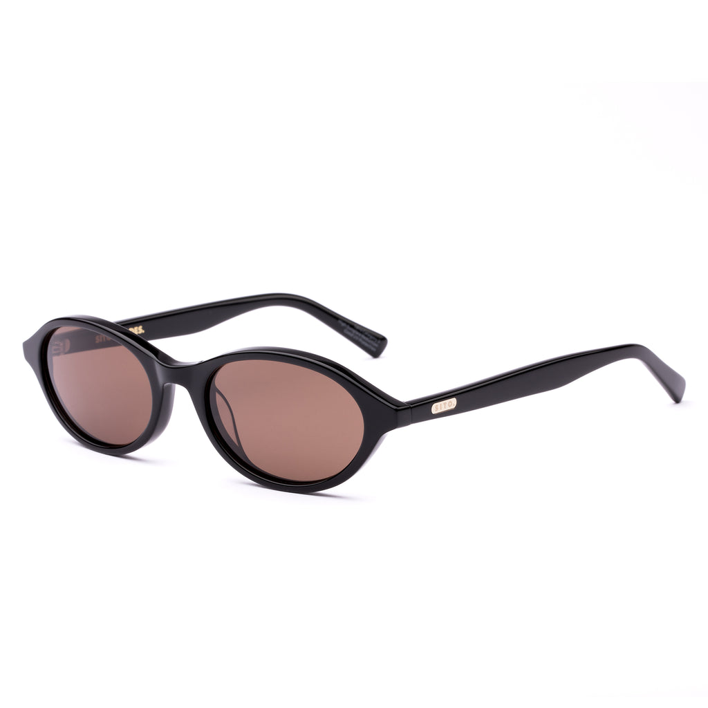 Black sunglasses with brown lenses on a white background