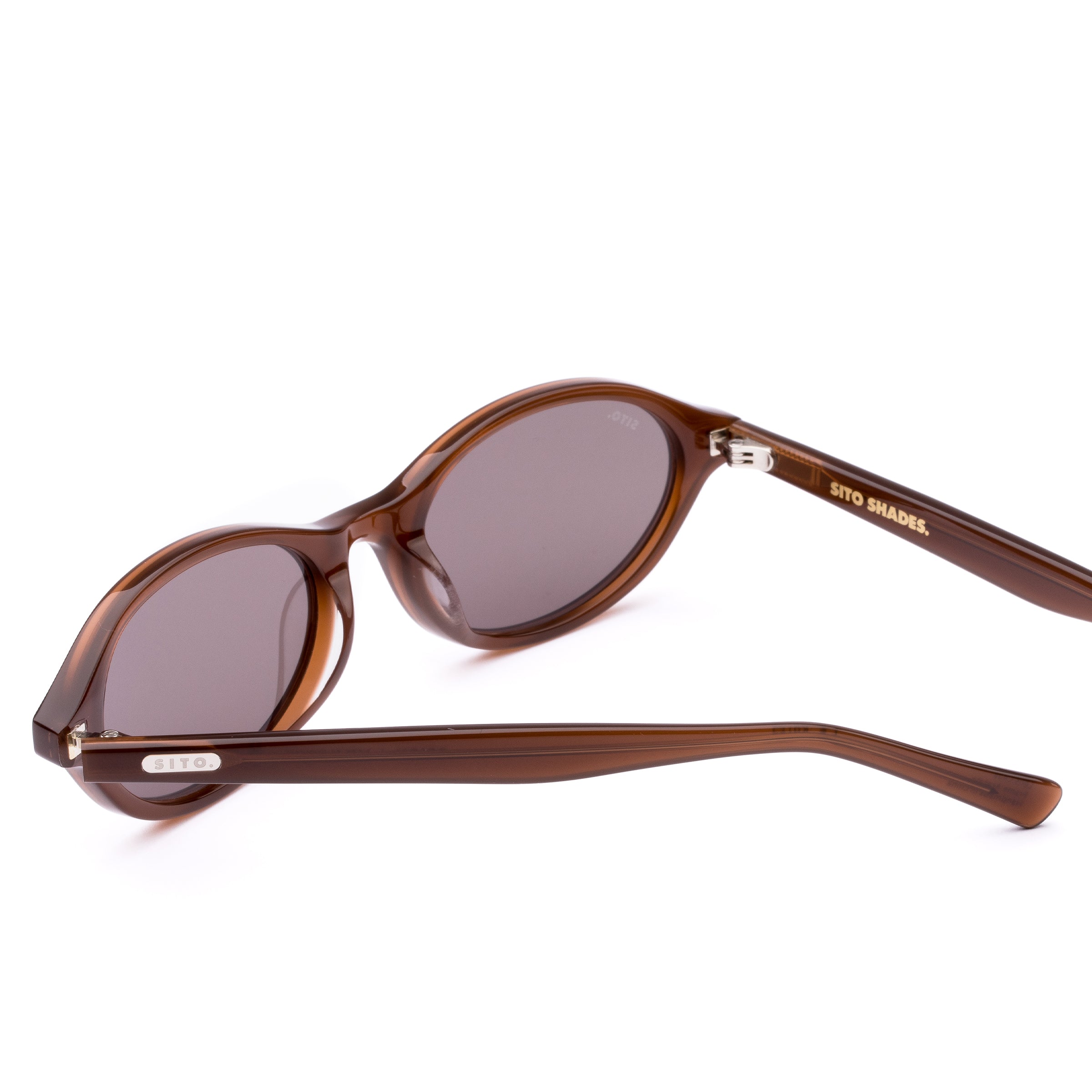 Brown sunglasses with a reflective lens on a white background