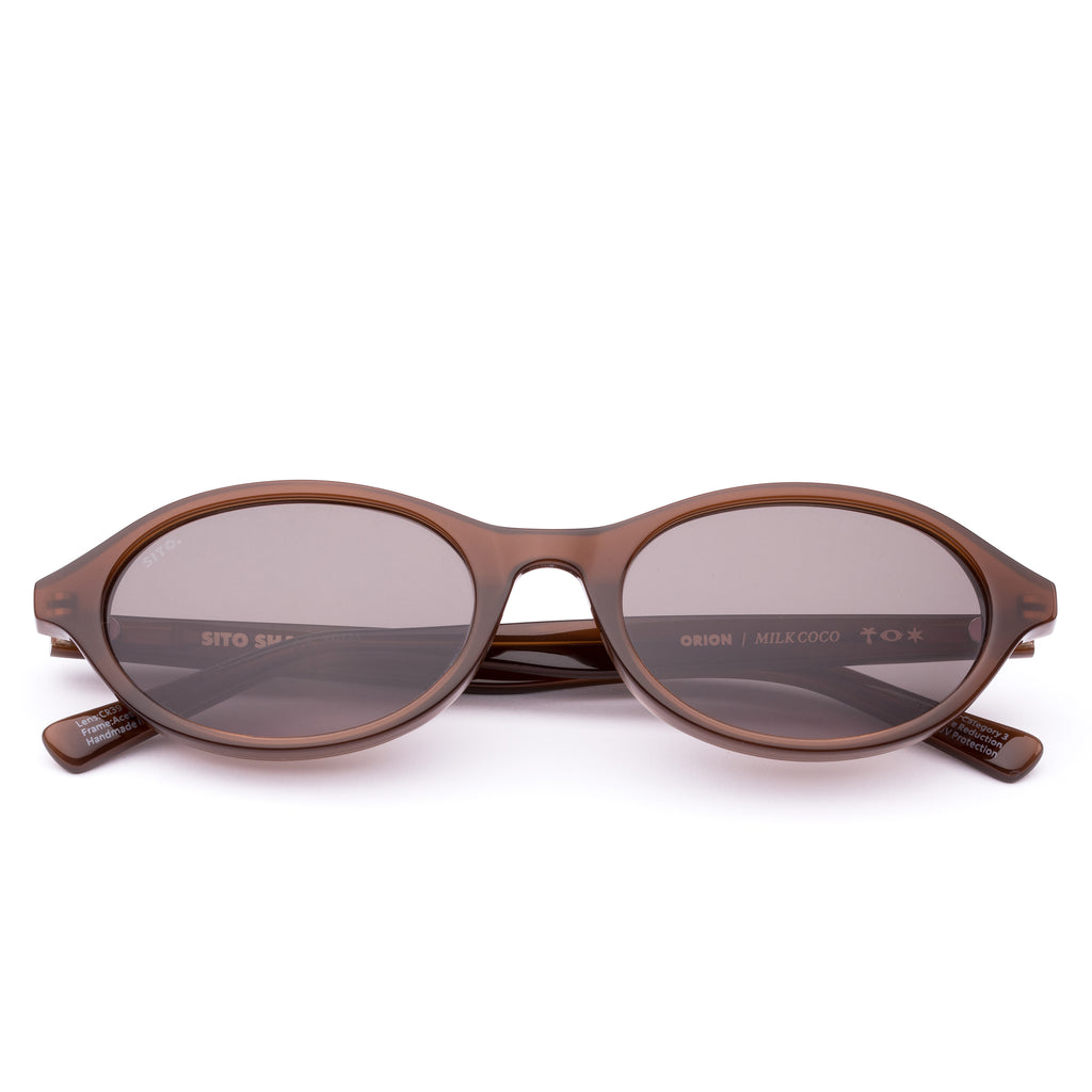 Brown sunglasses with a reflective lens on a white background