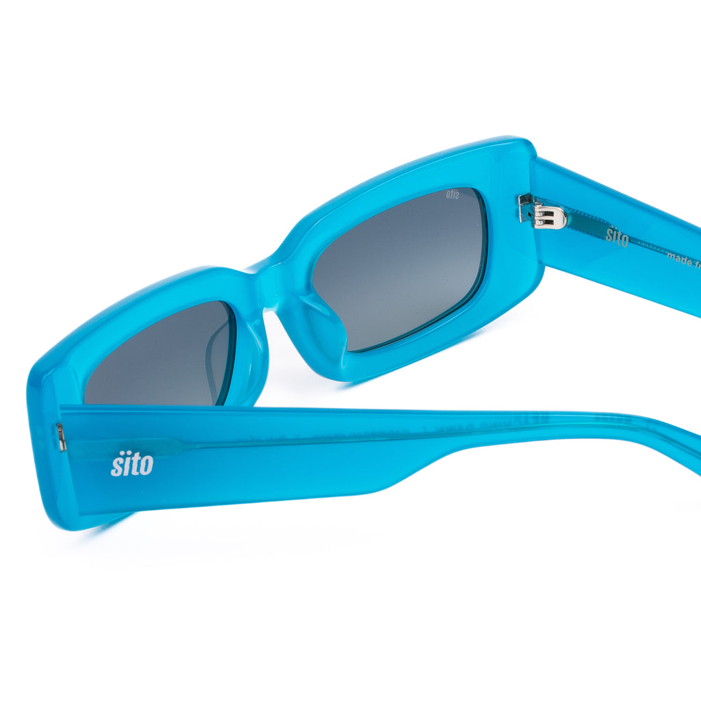 Blue sunglasses with a white background
