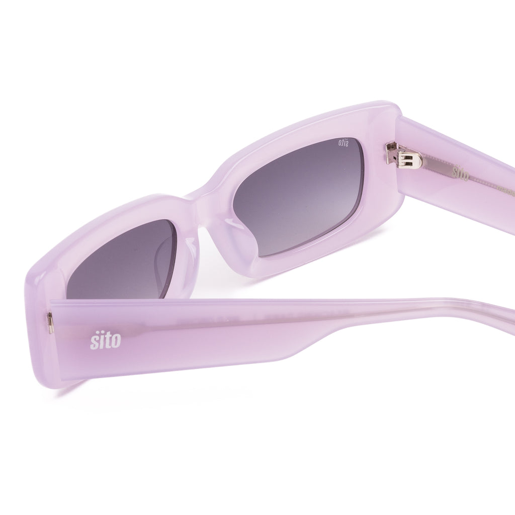 Pink sunglasses with dark lenses on a white background