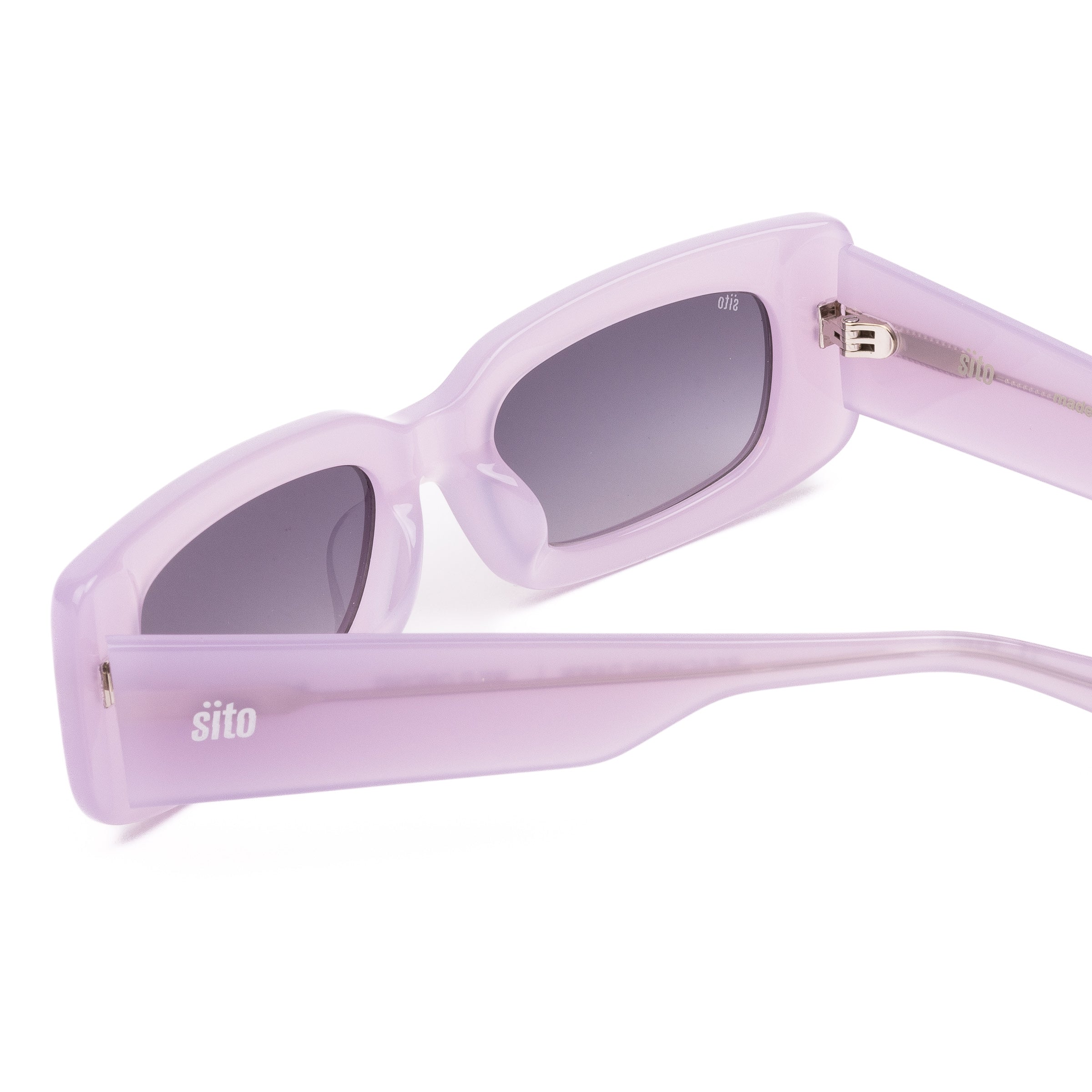 Pink sunglasses with dark lenses on a white background