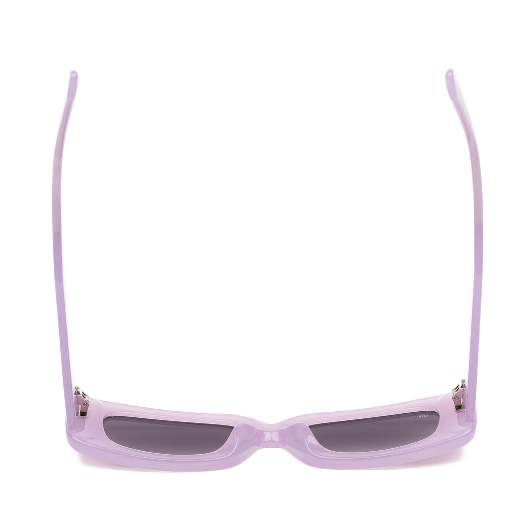 Pink sunglasses with dark lenses on a white background
