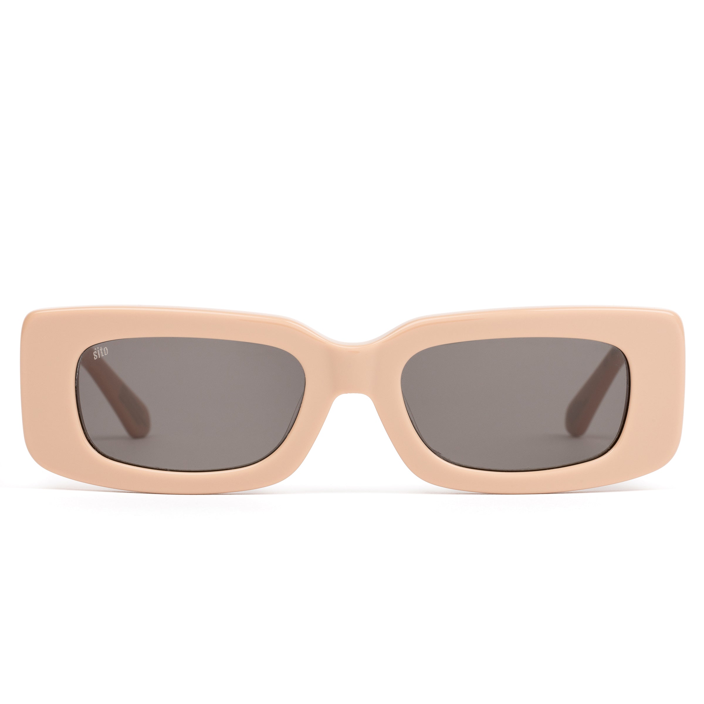 Beige sunglasses with dark lenses on a white background