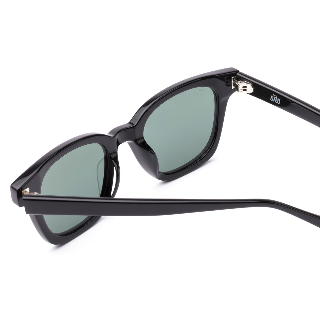 Black sunglasses with dark lenses on a white background