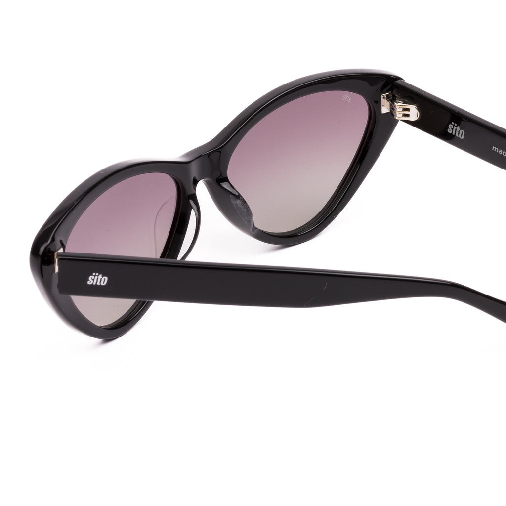 Black cat-eye sunglasses with pink gradient lenses on a white background