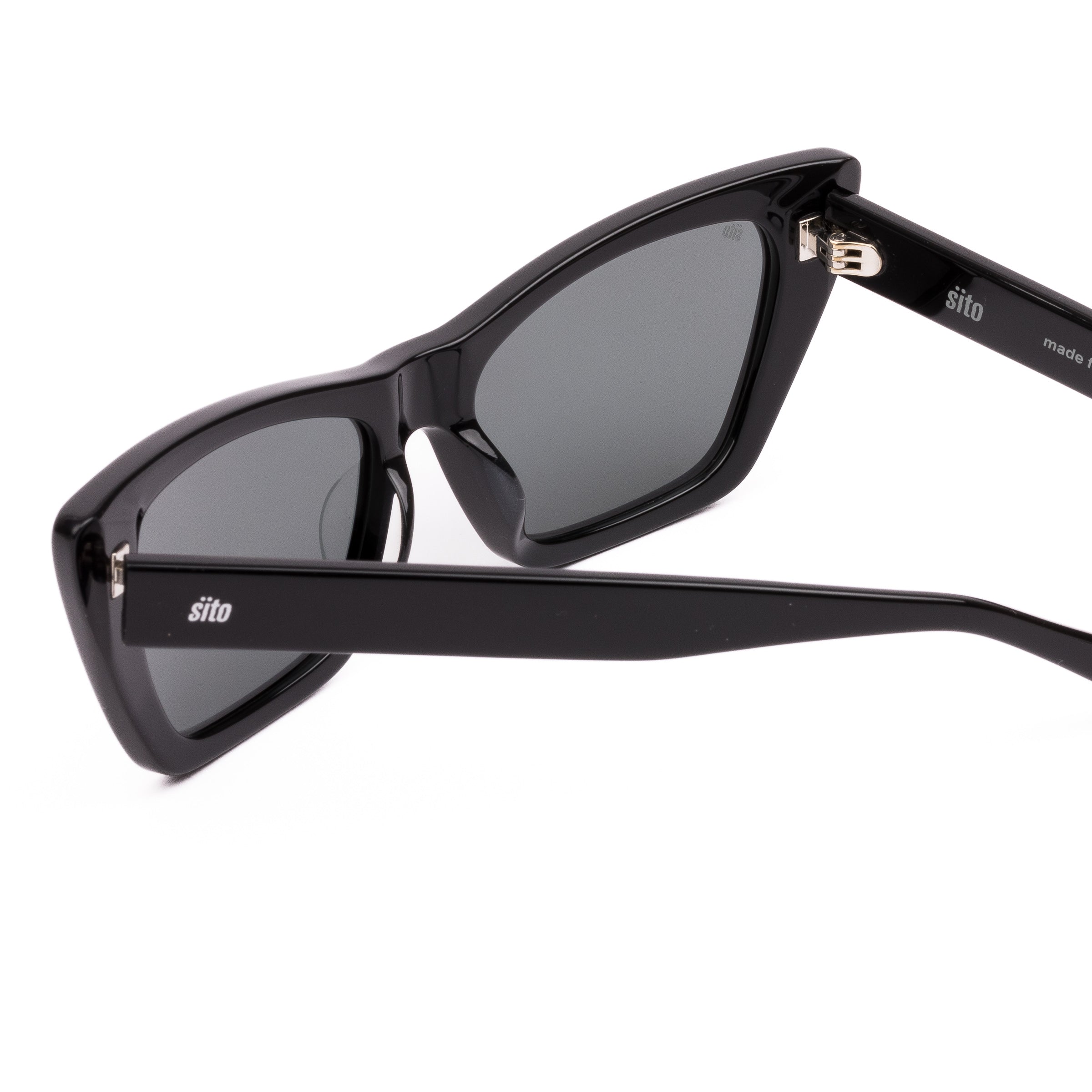 Black cat-eye sunglasses with dark lenses on a white background
